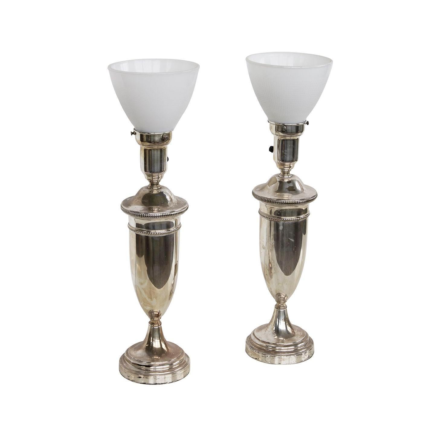USA, 1960s
Pair of classical silverplate Lamps with glass diffusers. Felt lined base. Small to medium scale.
DIMENSIONS: 5