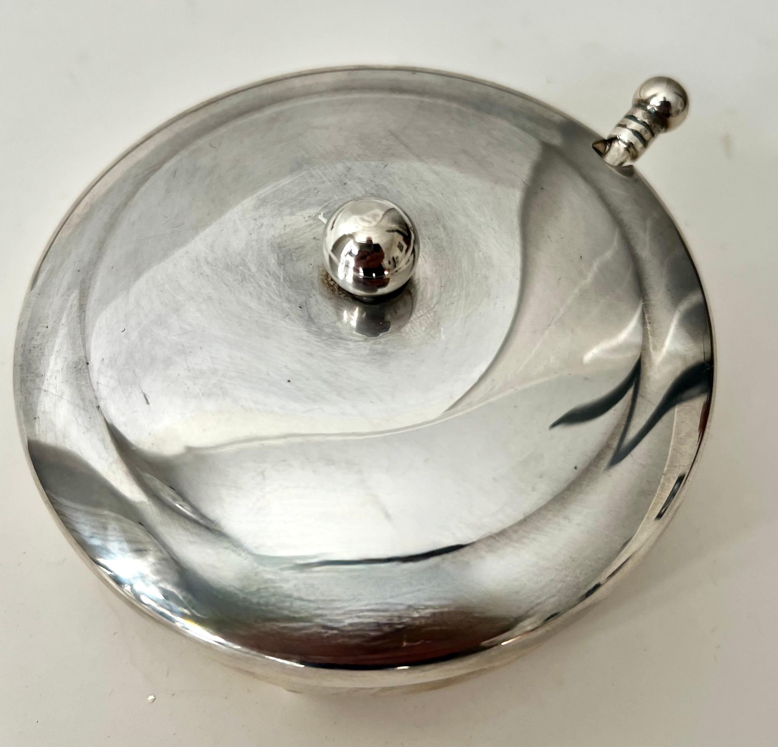 A simple, yet sophisticated Sugar or Condiment bowl with spoon.  The piece is very elegant and when polished, a true winner. 

A lovely addition to your breakfast table or use at the bar as well.