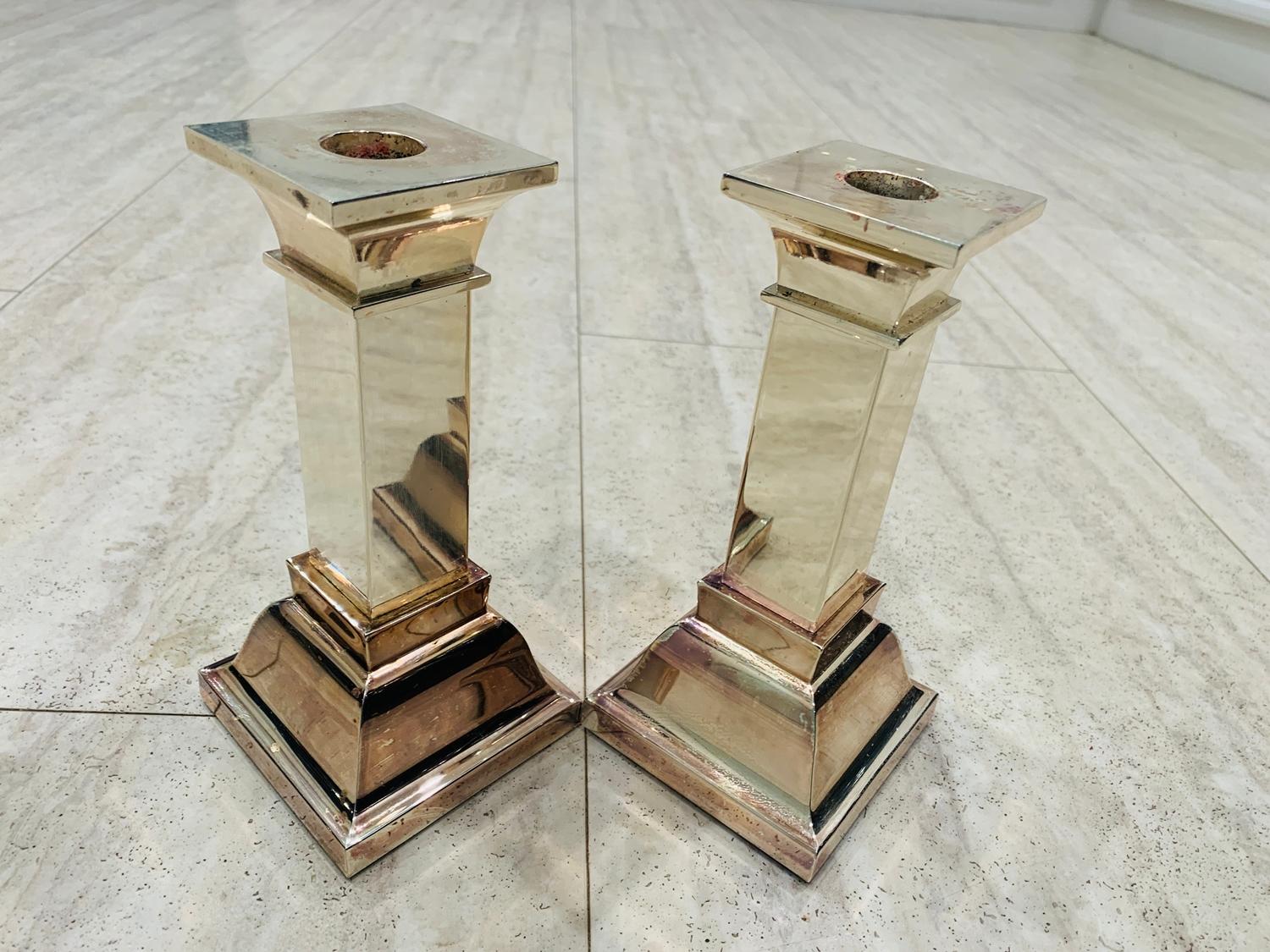 Pair of silverplated candle holders by Lunt, The pieces need to be polished, they show some wear and wax residue.

Measurements:
7 inches high x 3.25 inches square at base x 2.25 inches square at top and they use 7/8 candles.
 