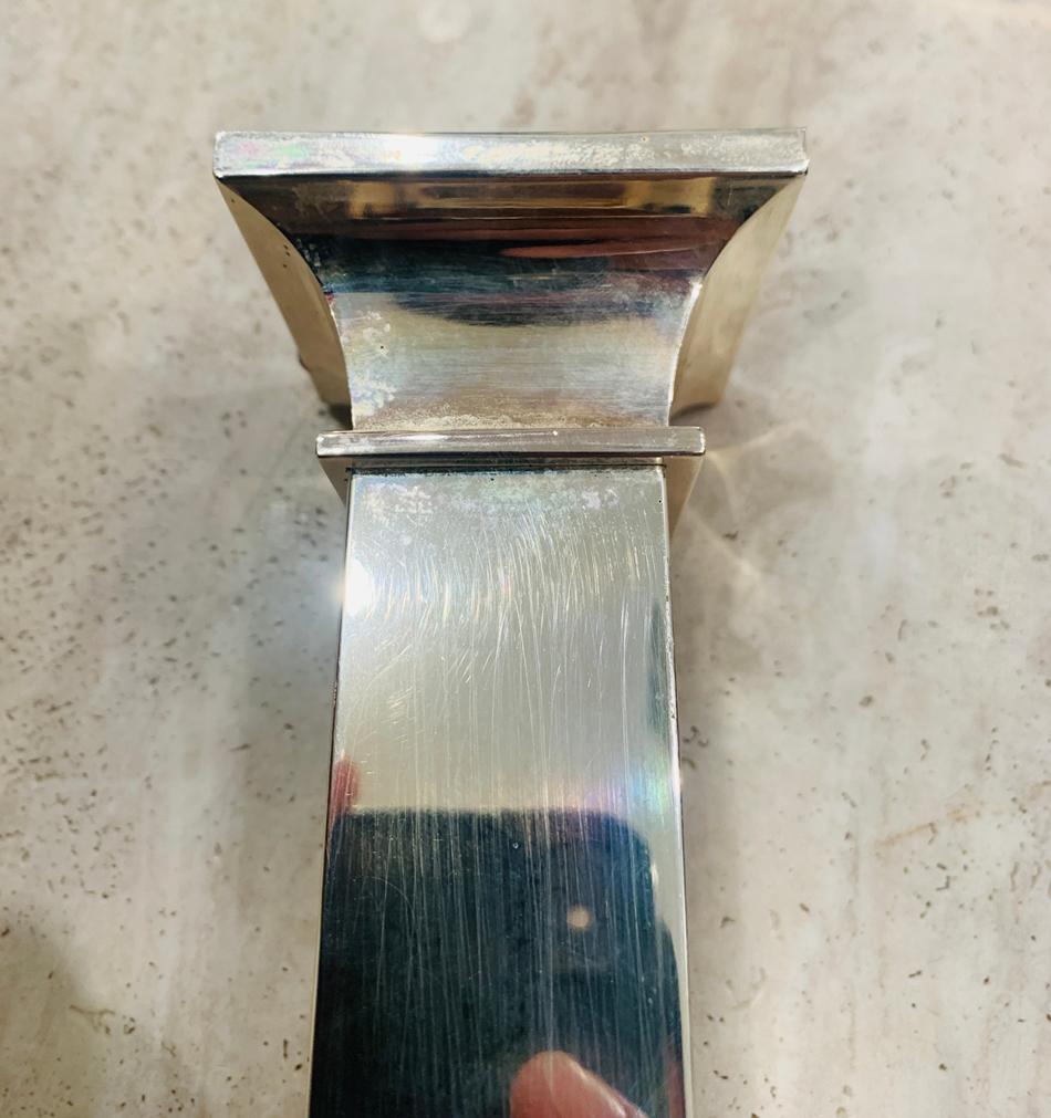 Silverplated candle holder by Lunt, The piece needs to be polished, it shows some wear and wax residue.

Measurements:
7 inches high x 3.25 inches square at base x 2.25 inches square at top and they use 7/8 candles.
 