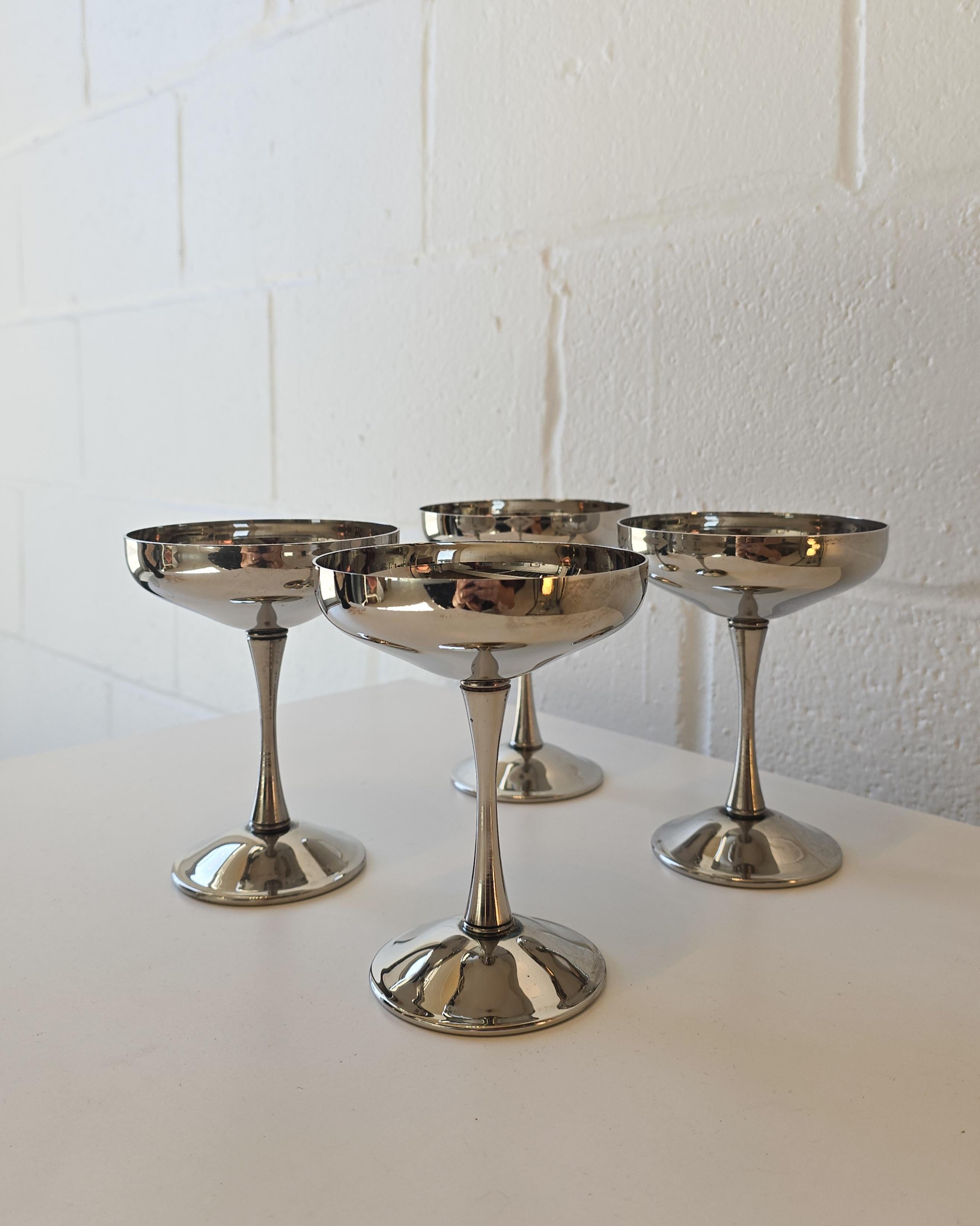 A set of four of silverplated coupe goblets made in Italy. Maker stamped on bottom of goblets. These art deco style champagne coupe goblets are silverplated and have retained their shiny silverplated colour. In overall good condition with some signs