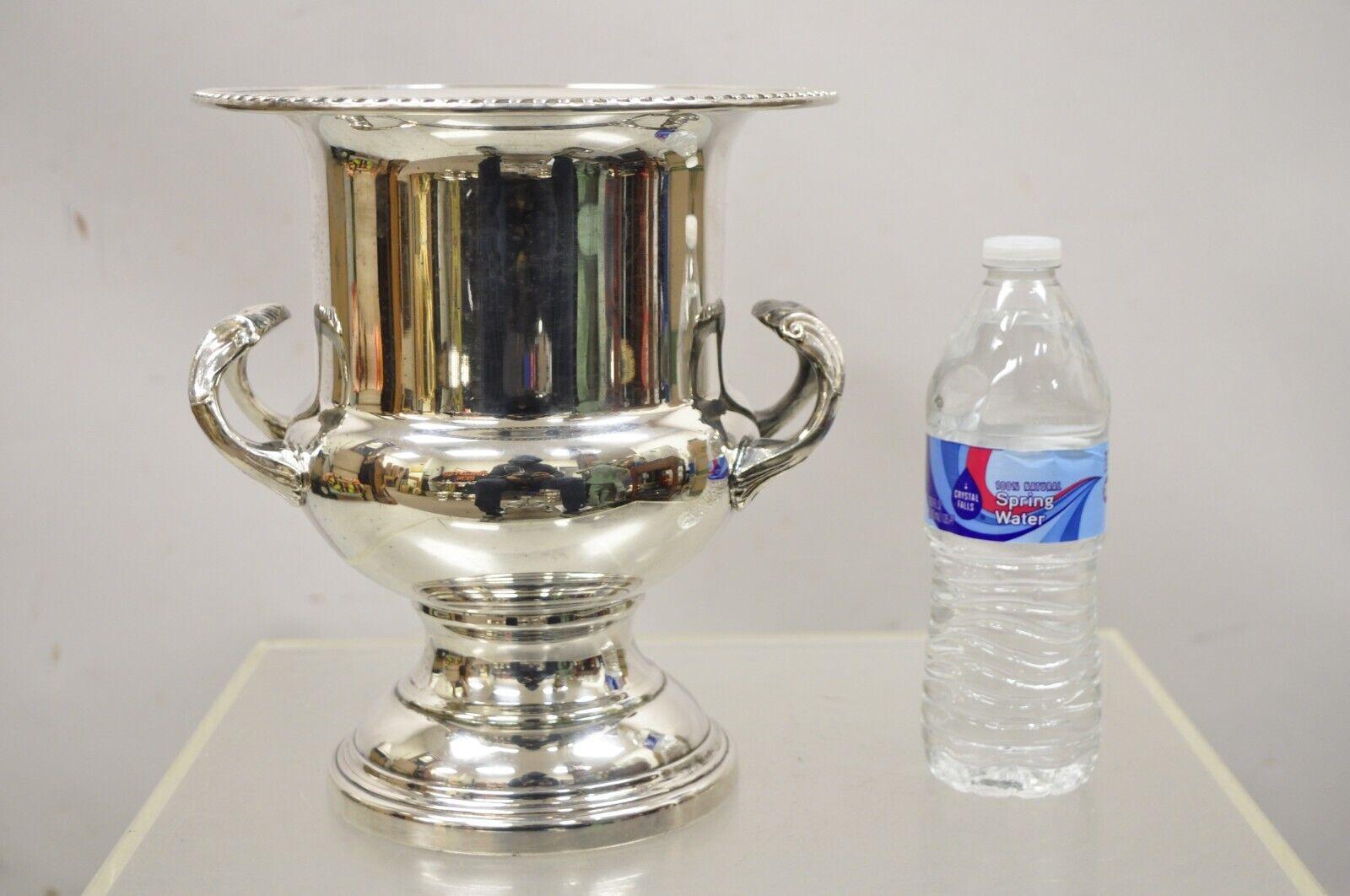 Vintage Silver Plated English Regency Style Twin Handle Trophy Cup Champagne Chiller Wine Ice Bucket. Item features ornate twin handles, raised pedestal base, decorated rim, unmarked, very nice vintage item, great style and form. Circa Mid 20th