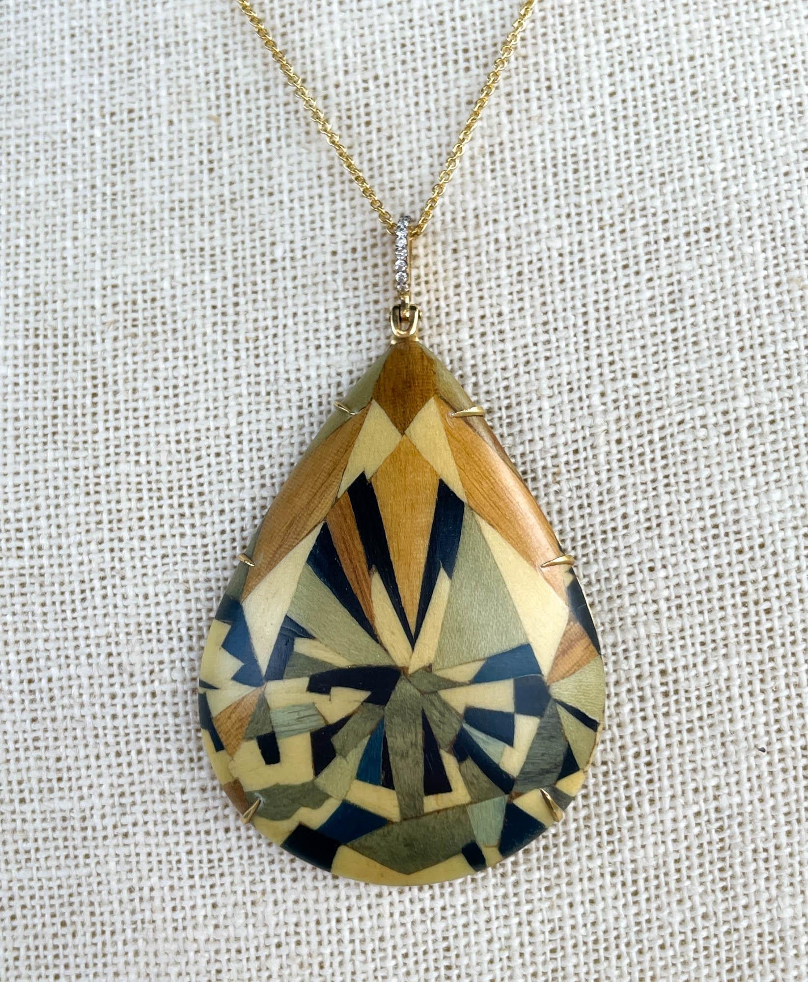 Silvia Furmanovich 18k Yellow Gold Diamond Teardrop Marquetry Wood Pendant
Set with round brilliant diamonds; estimated total weight is 0.05ctw.
The pendant is 2 3/8 inches; Teardrop’s measurements are 48x31mm.
The total weight is 9.2 grams.
Pendant