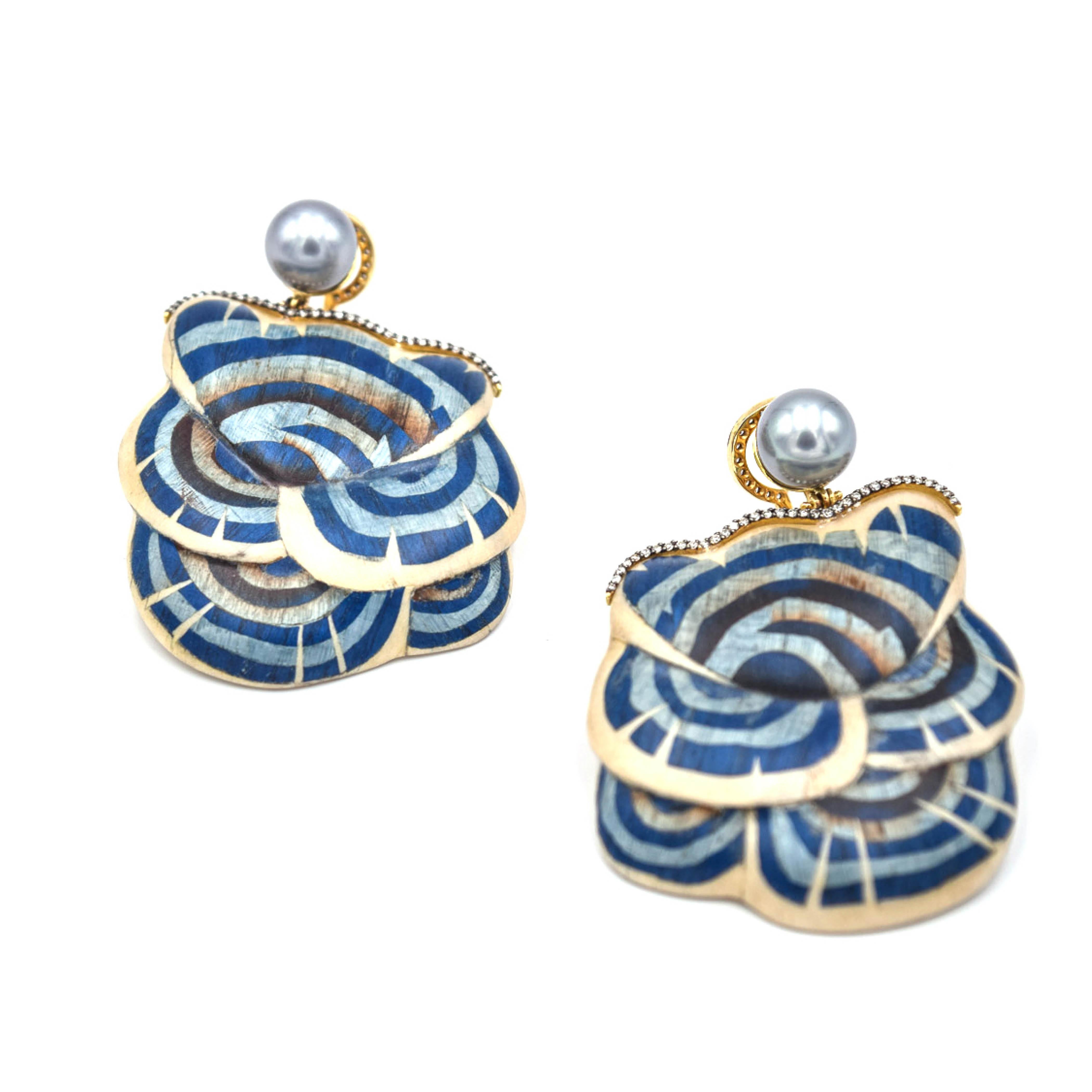 Exposing the rich colors and patterns embedded within cultures all around the world, Silvia Furmanovich designs distinctive jewelry inspired by nature and ancestry.

These blue mushroom marquetry earrings feature grey pearls and light brown