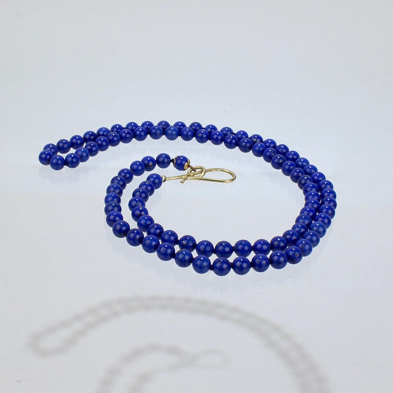 A very fine opera length necklace by Silvia Kelly.

With 8mm blue Lapis Lazuli round beads and a hammered hook-and-eye 18k gold clasp.

Marked to the clasp: 750 for 18k gold fineness, Silvia Kelly, and Italy.

 An incredibly versatile and wearable