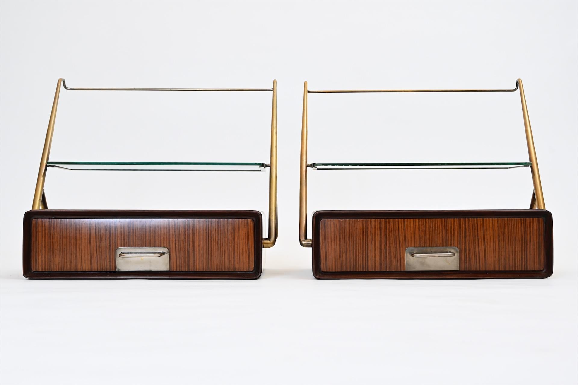 Midcentury bedside cabinets or wall shelves in walnut.

Brass, glass and walnut.