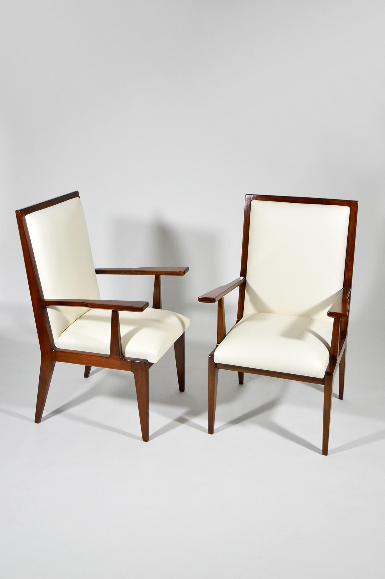 These chairs, made of Italian solid walnut, were designed by Franco Cavatorta for his family firm Silvio Cavatorta, circa 1950. They have been fully restored and upholstered with warm white good quality faux leather. Original metal plate 
