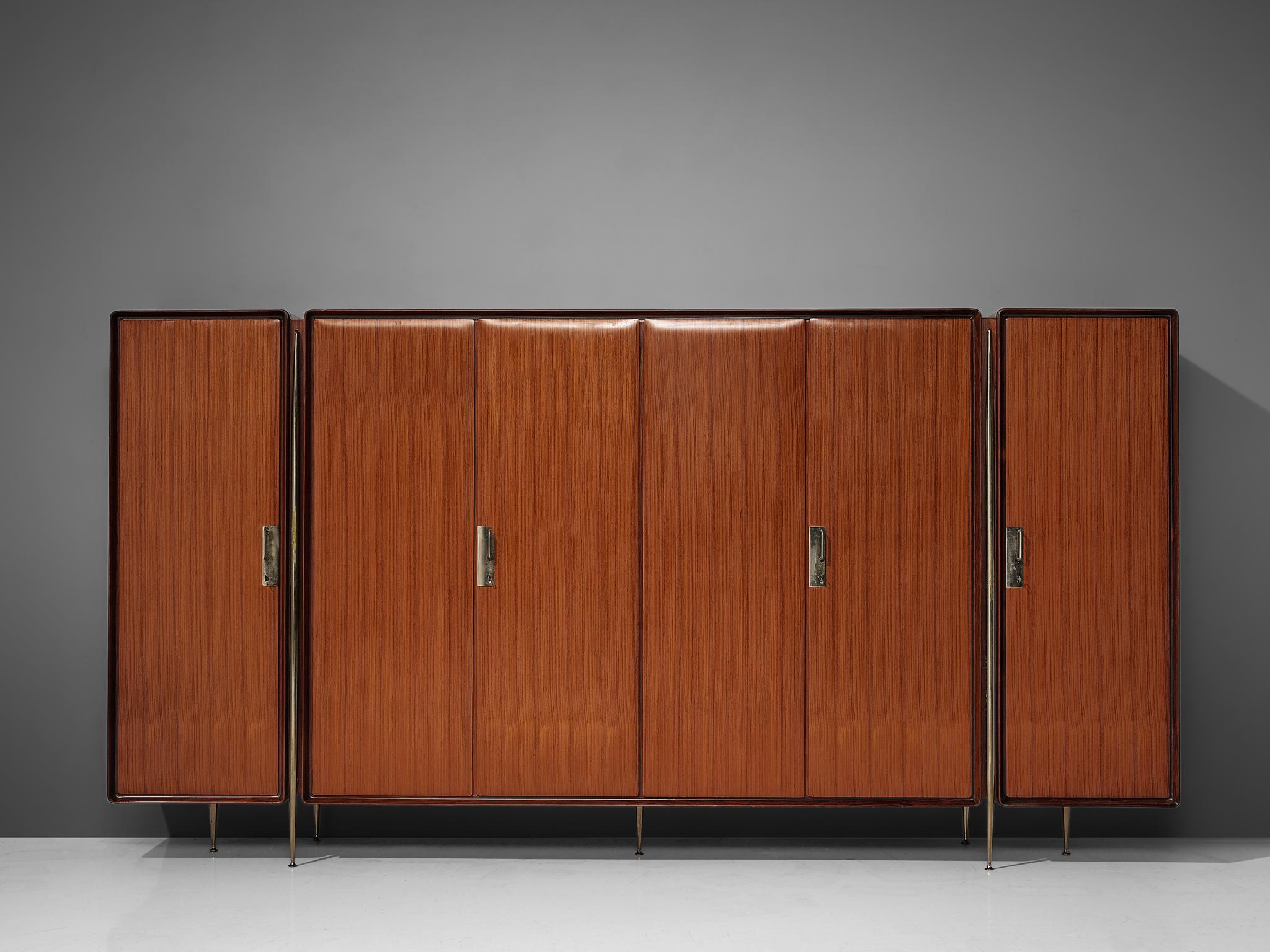 Silvio Cavatorta, wardrobe, mahogany, birch, nickel-plated brass, Italy, 1950s. 

Italian wardrobe in mahogany and birch by Silvio Cavatorta. The wardrobe is visually structured in three parts. One large compartment with three doors and one door on