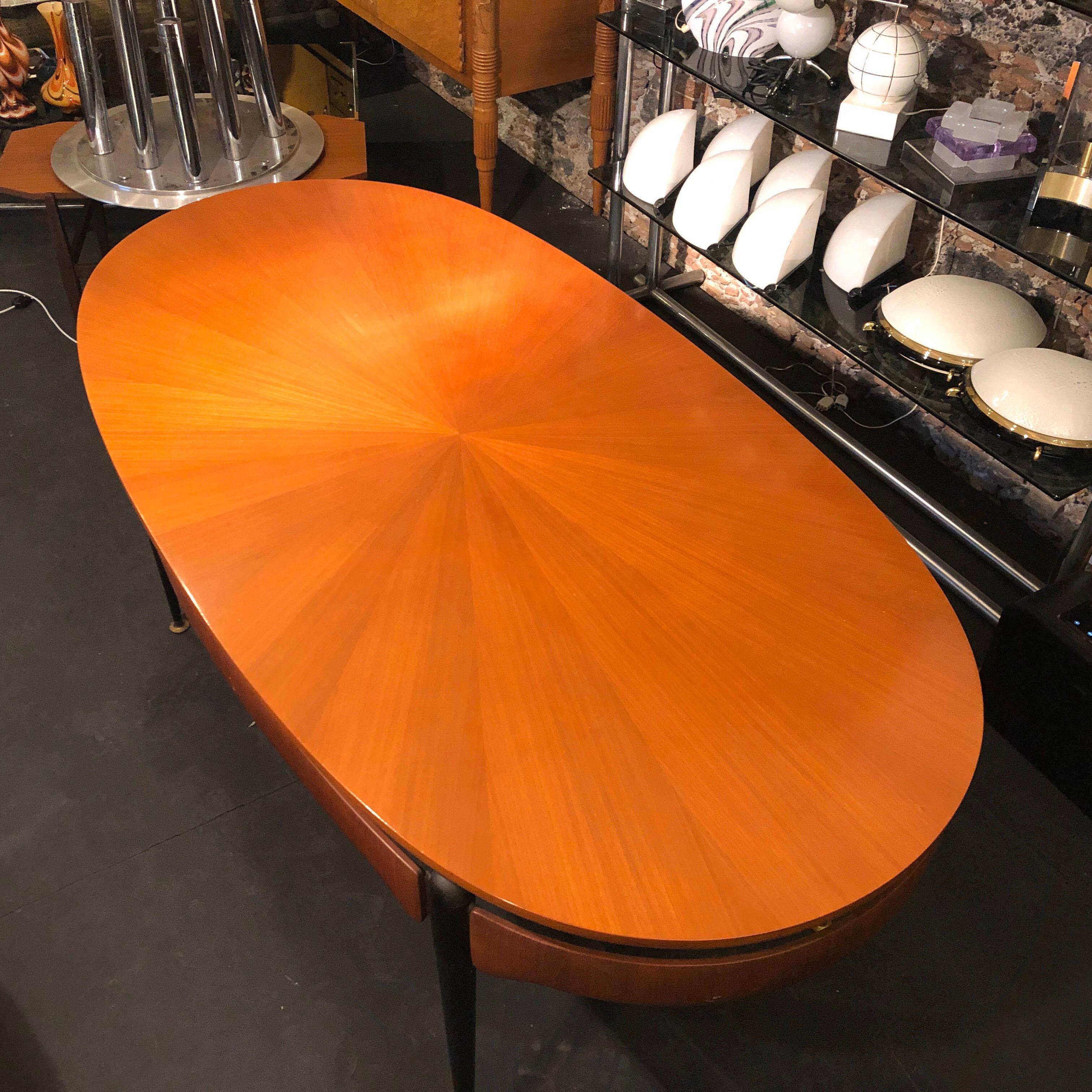 Amazing rosewood and brass oval dining table designed by Silvio Cavatorta, ebonized table legs with brass inserts, good conditions overall.