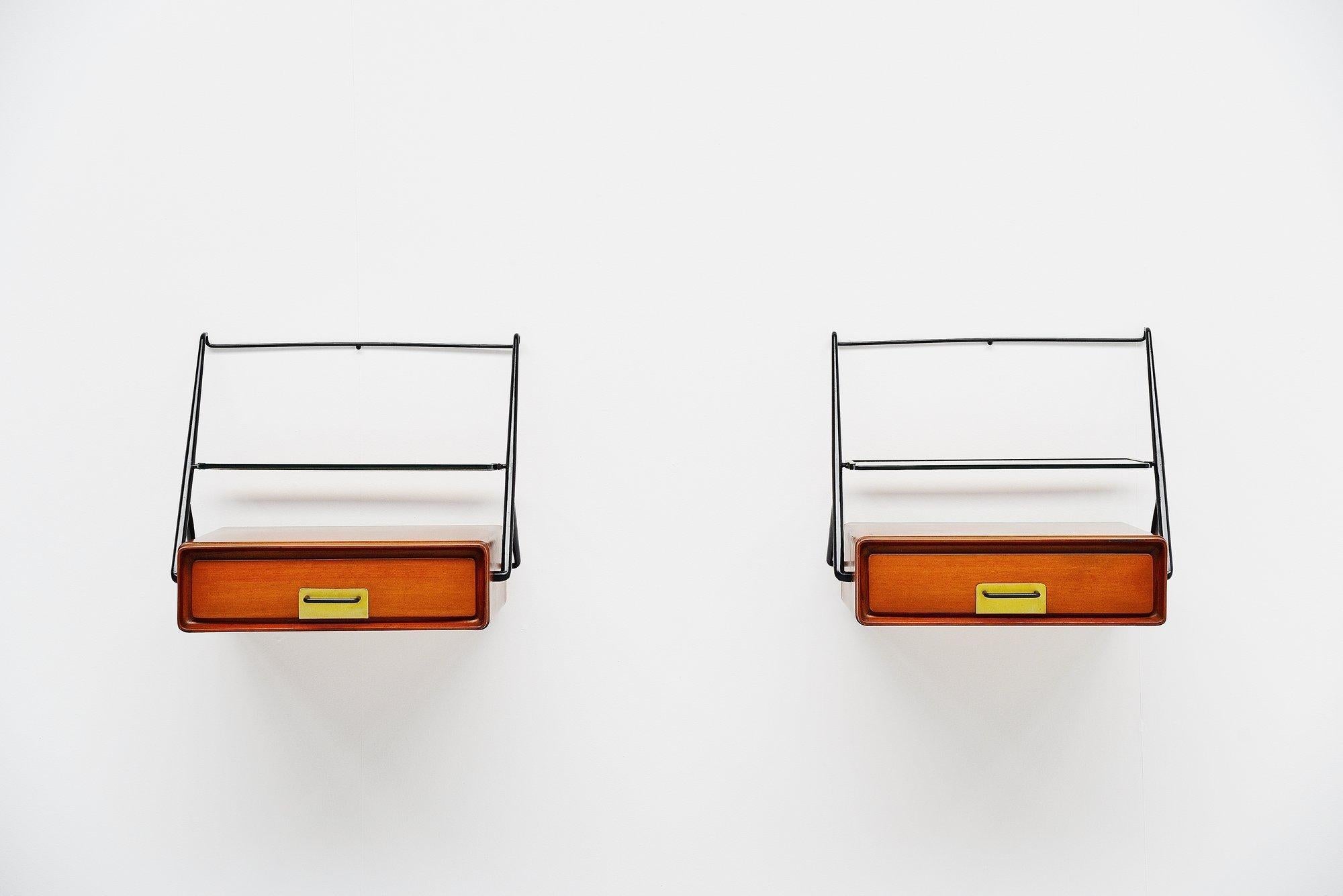 Stunning pair of wall mounted night cabinets designed and made by Silvio Cavatorta, Italy, 1958. This highly refined cabinets have a black lacquered brass hinges with brass drawer handles and a glass shelve. The cabinets are made of semi gloss