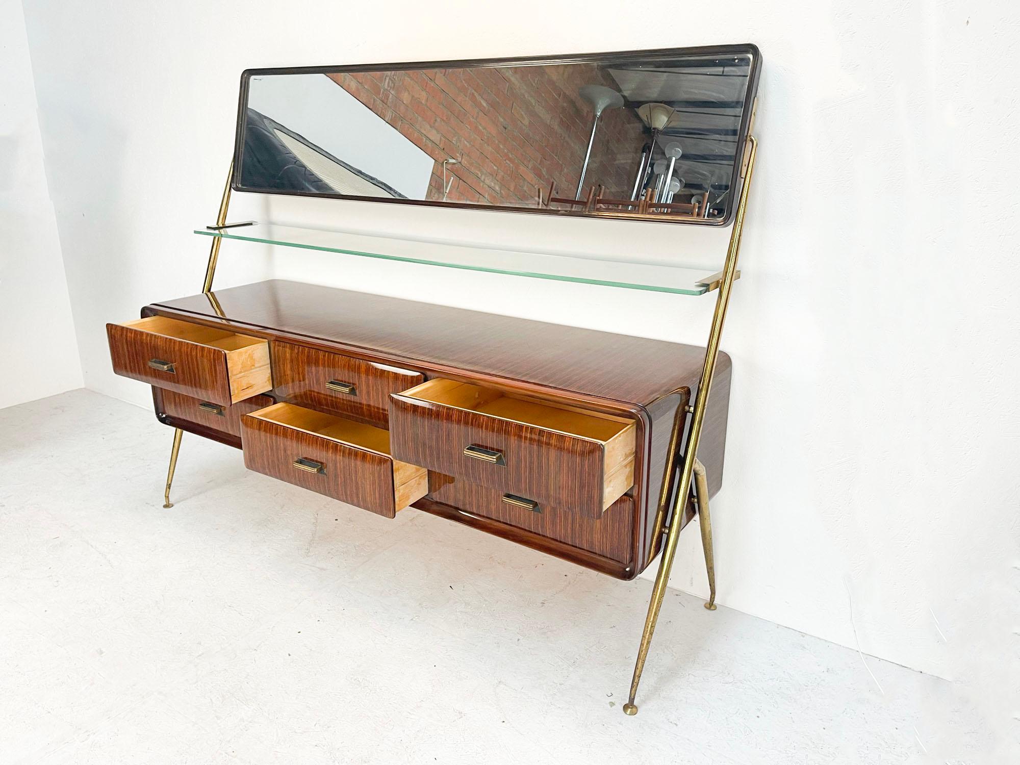 A true Italian Beauty! 

Beautiful sideboard designed and manufactured by Silvio Cavatorta, Italy in 1958. This sideboard is a perfect example of Italian craftsmanship. The sideboard is made of high gloss lacquered teak wood with a brass