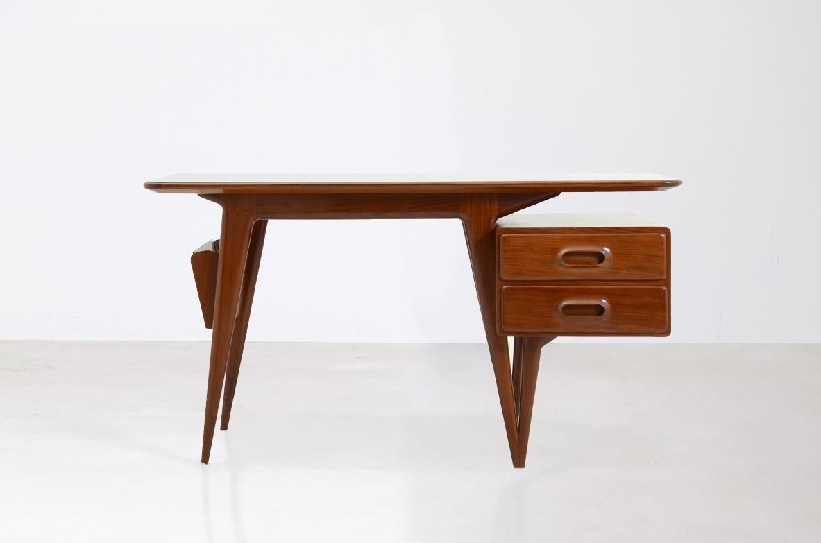 Silvio Cavatorta

Stunning desk table in cherry wood with drawers locked on the side and original burgundy glass top.
Italian manufacture, 1950s.