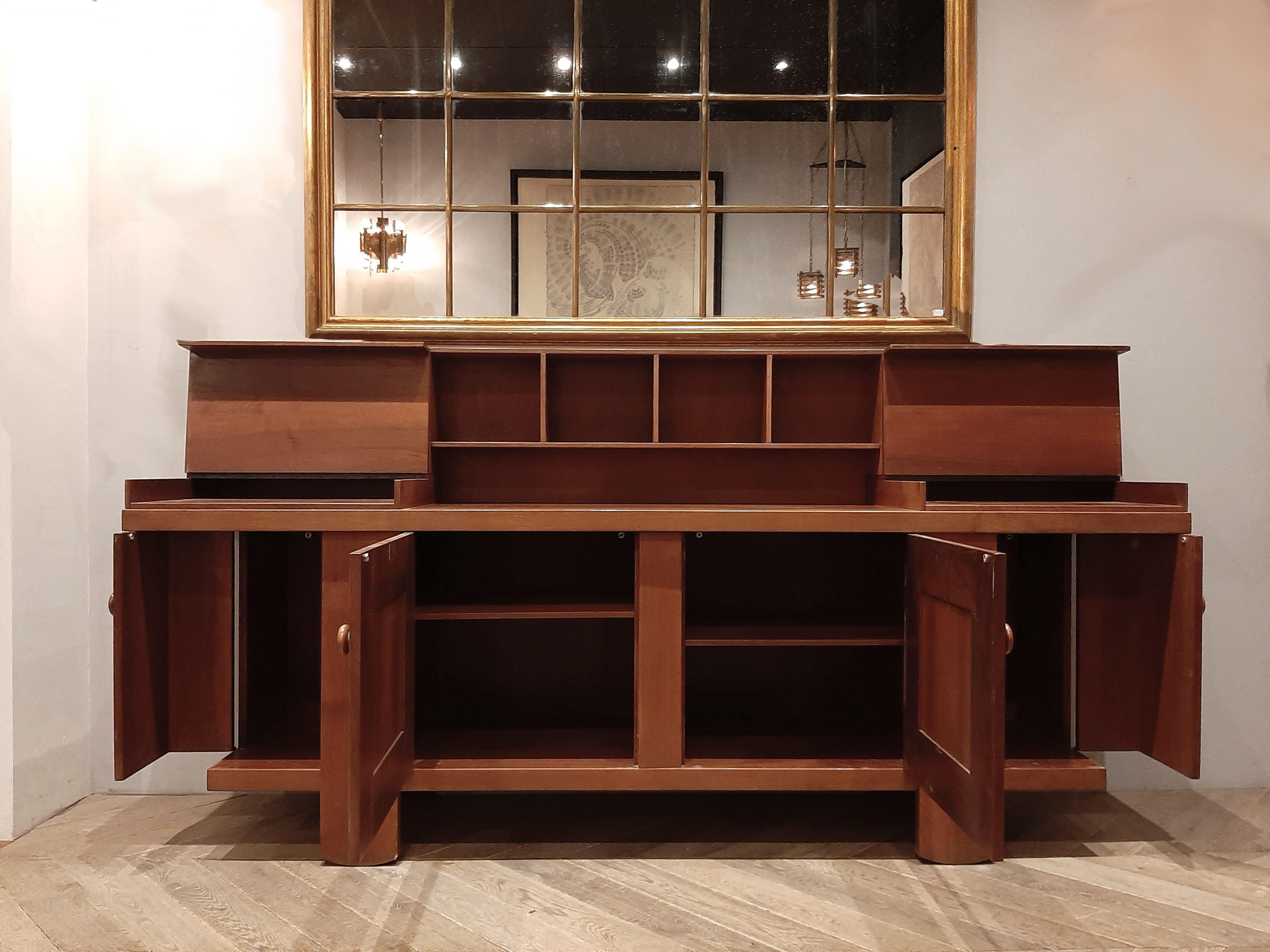 A midcentury Italian buffet cabinet designed by Silvio Coppola for Bernini. This walnut cabinet features two end doors revealing adjustable shelves on each side and storage, two center doors each revealing and adjustable shelf and a detachable top