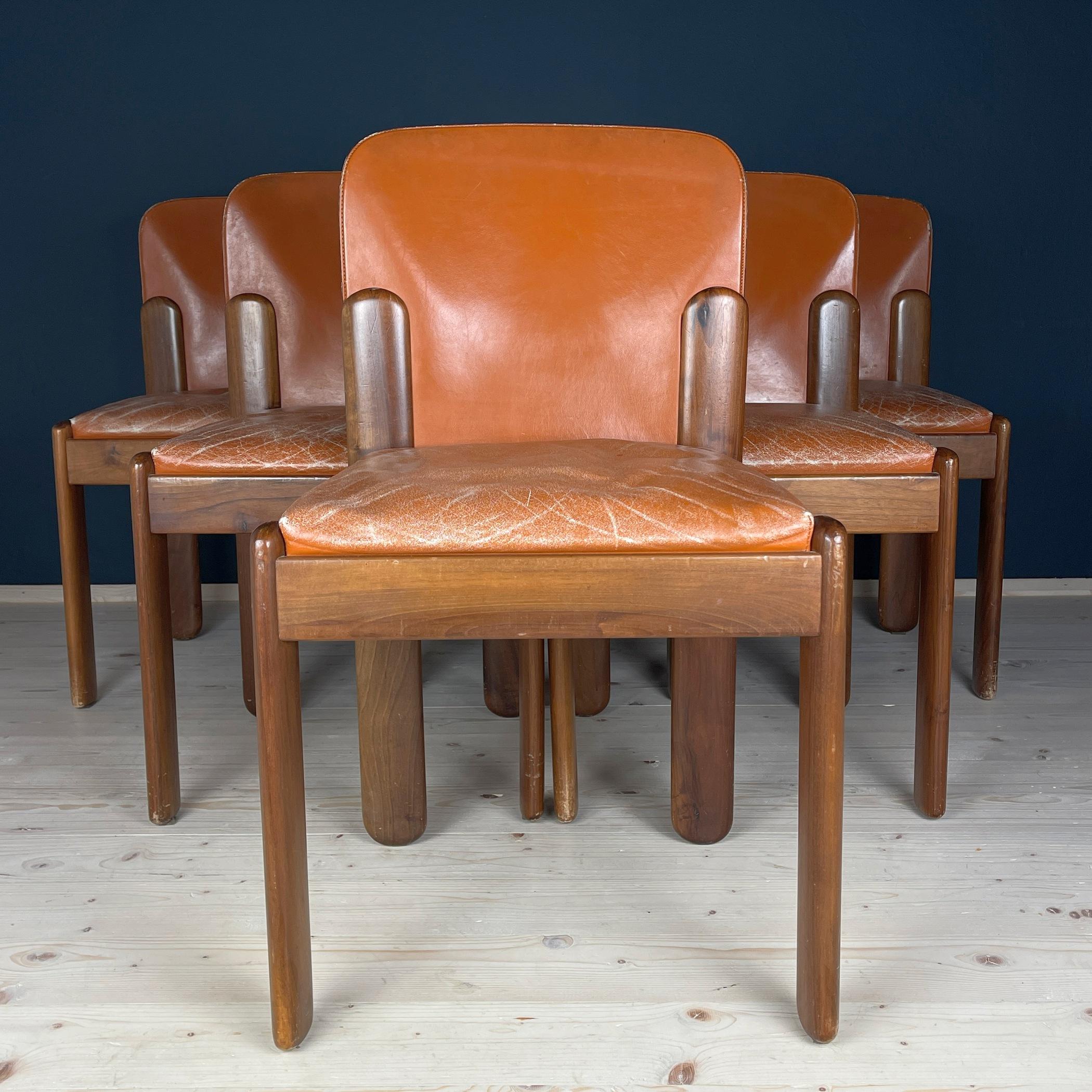 Immerse yourself in the timeless elegance of Italian design with this stunning set of six chairs crafted by Silvio Coppola for Bernini in the 1960s. Model '330' captivates with a visually stylish blend of rich cognac leather and warm walnut wood,