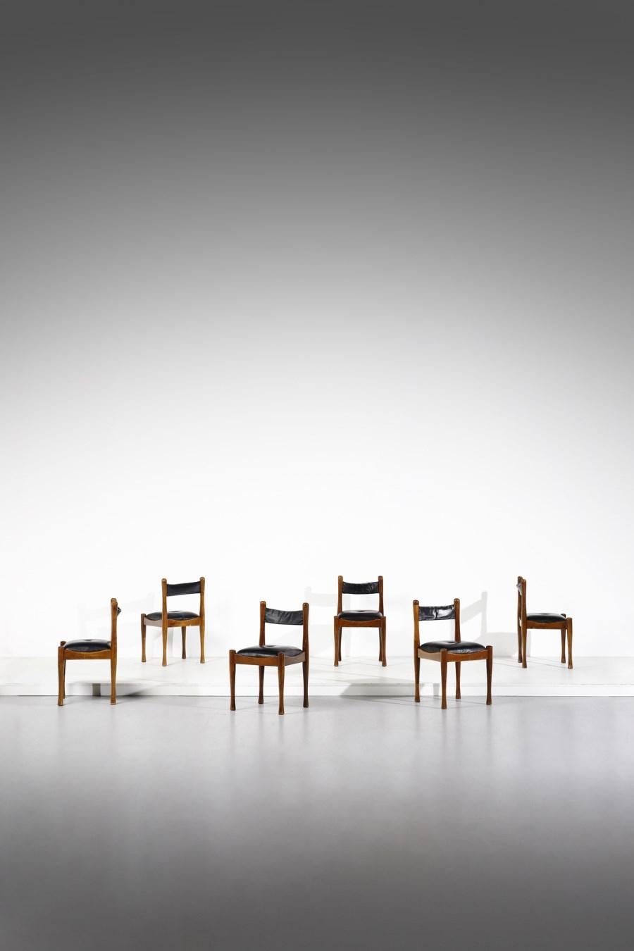 Silvio Coppola for Bernini, set of 6 dining chairs, stained wood, black leather, Italy, 1960s

These chairs were created by Silvio Coppola for Bernini in the 1960s. They have a dark frame and black leather seats, with leather backrests. The frame's
