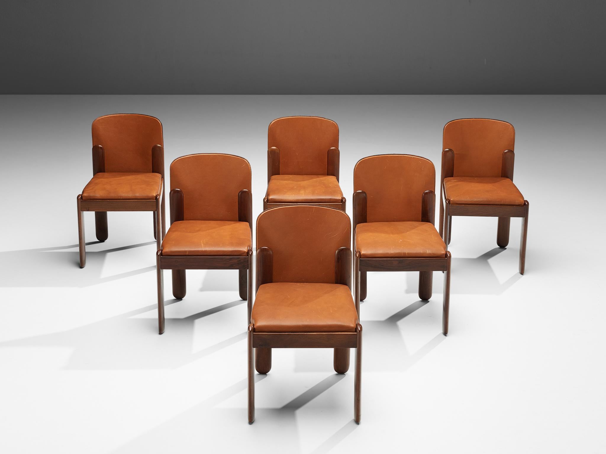 Silvio Coppola for Bernini Italy, set of six dining chairs, cognac leather and walnut, Italy, 1960s.

This set of six dining chairs is designed by Italian designer Silvio Coppola. These chairs have a cubic and architectural appearance. The base