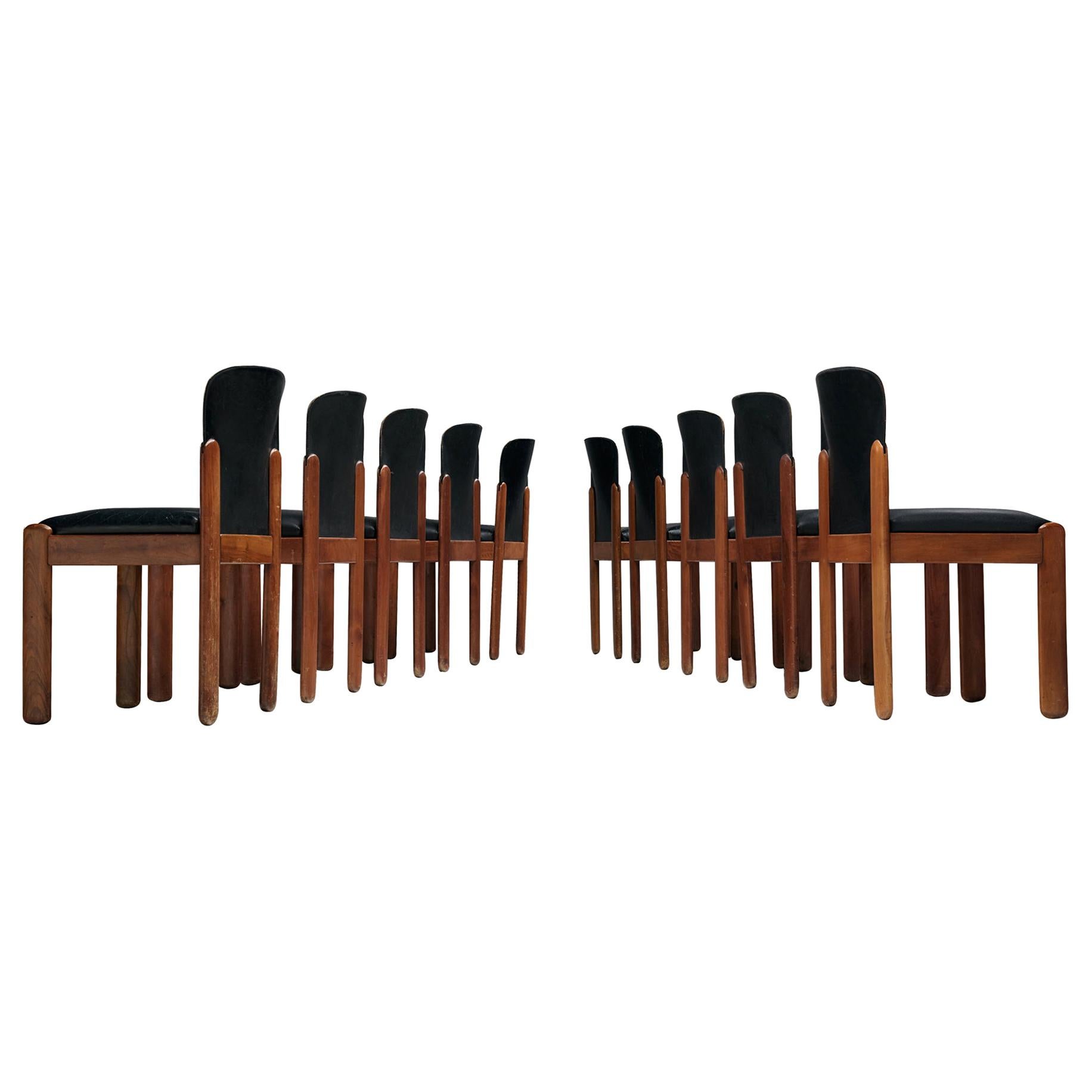 Silvio Coppola for Bernini Italy, set of ten chairs, black leather and stained beech, Italy, 1960s.
 
Set of ten chairs by Italian designer Silvio Coppola. These chairs have a cubic and architectural appearance. The base consist of four straight
