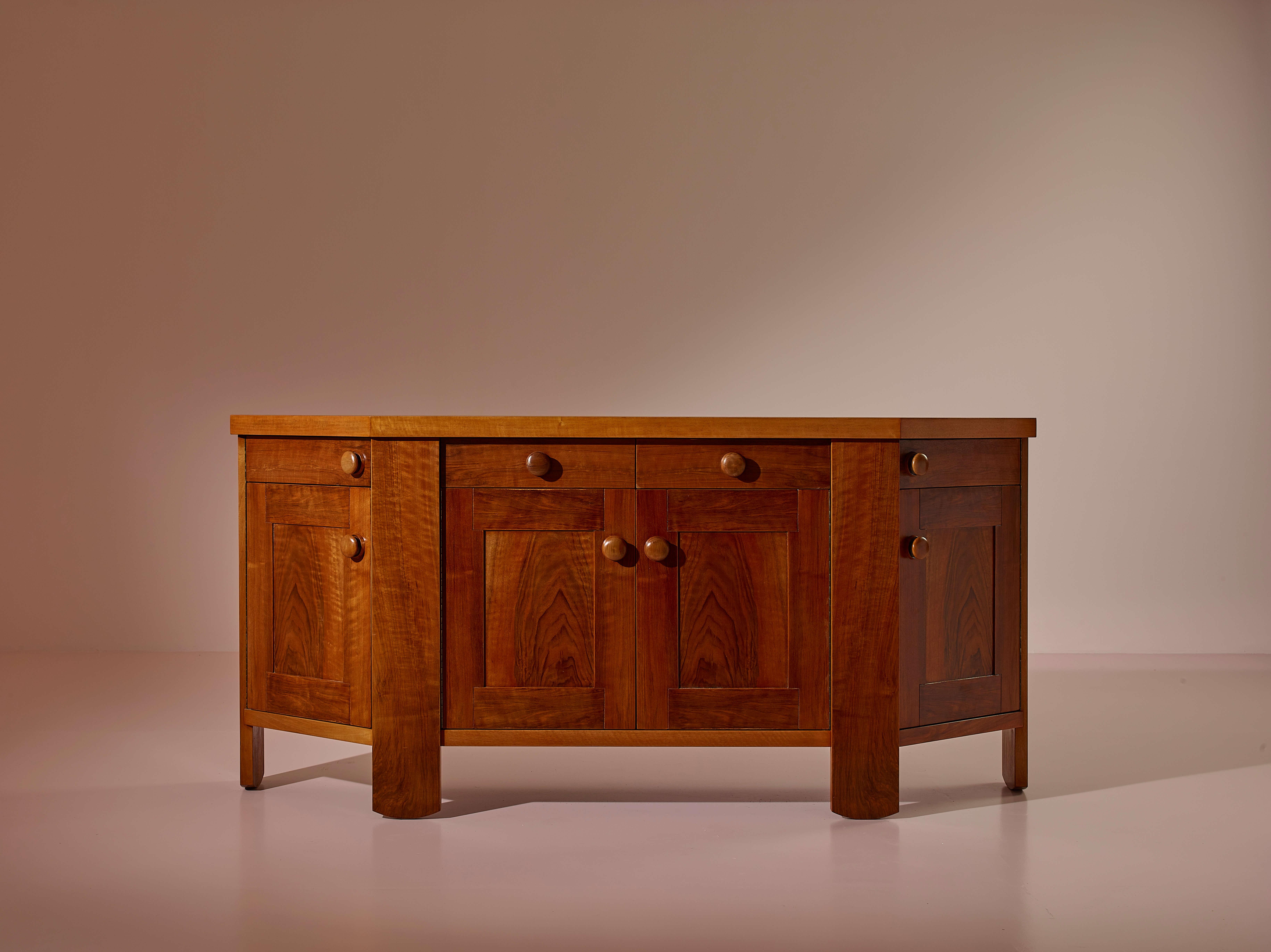 Sideboard with Doors and Drawers, Walnut Wood, Italian Production, Design by Silvio Coppola, 1960s

Wood takes center stage in this architecturally shaped sideboard, which fits into the long Italian tradition of handcrafted furniture. The design is
