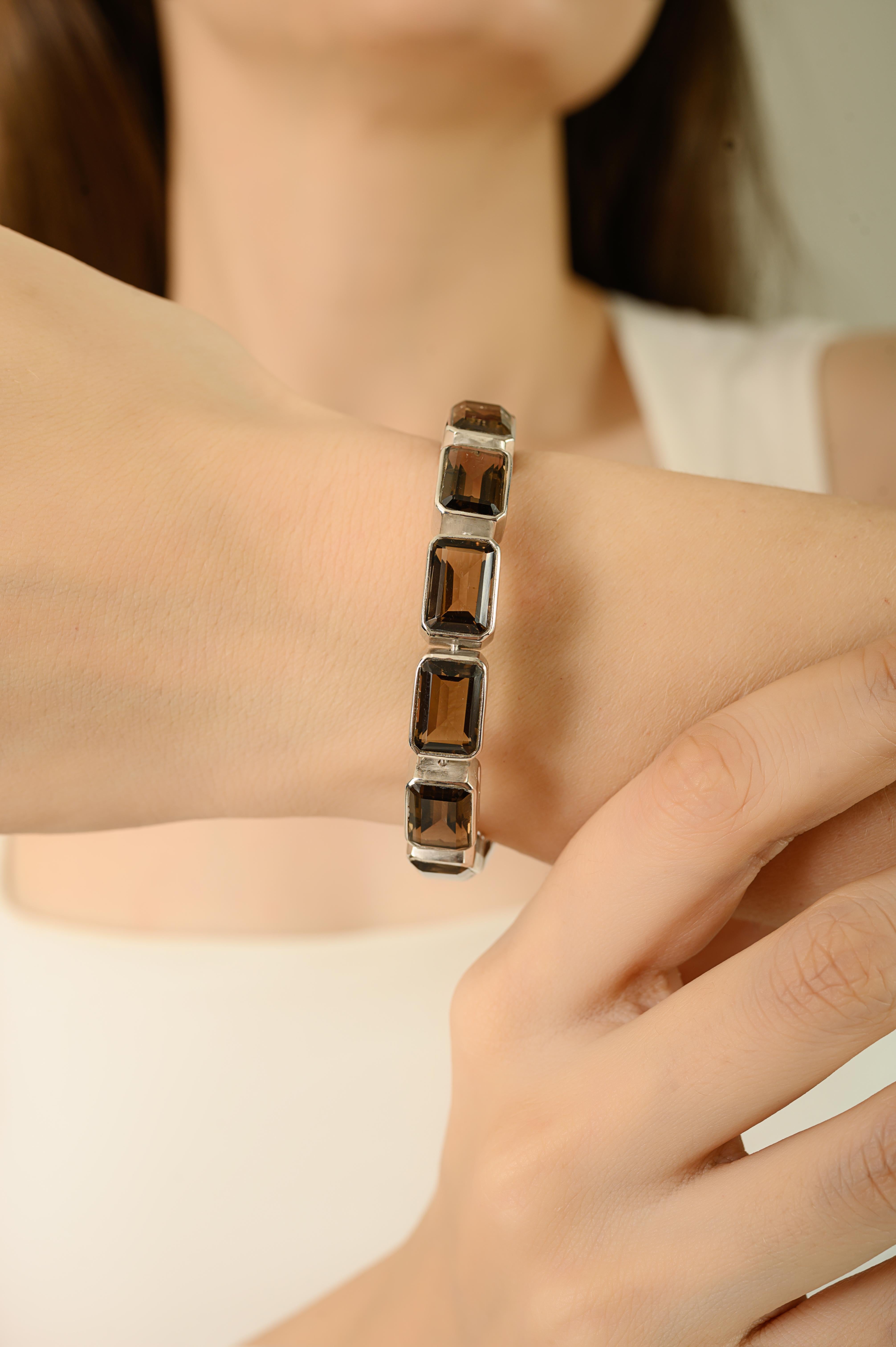 This bracelet is made in 925 sterling silver and features 13 smoky quartz gemstones in an octagon shape. Each stone is 11X7 mm in size with a total gemstone weight of 30.32 carats, bracelet is 7 inches long and weighs 87.1 grams, giving it a solid