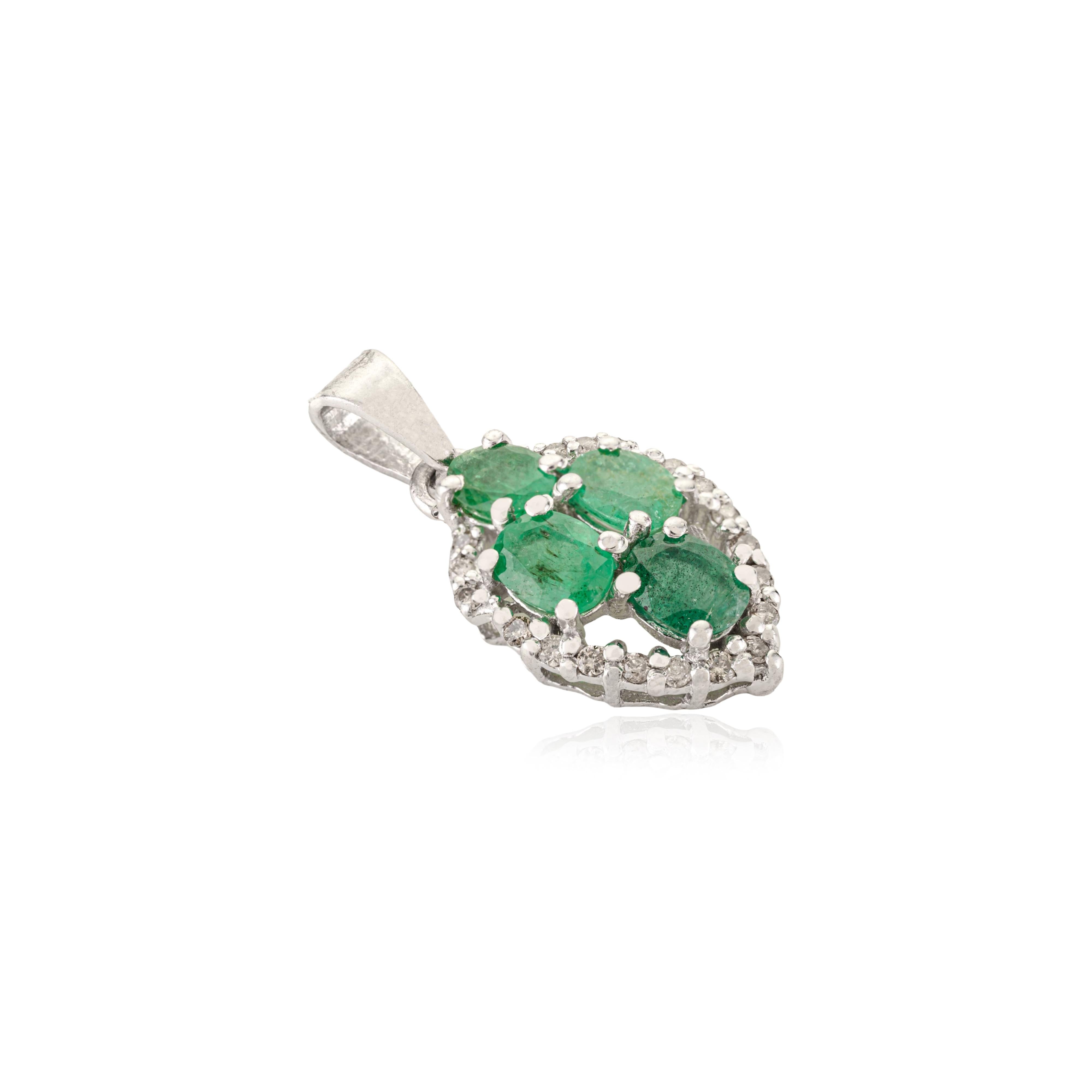 This elegant 925 sterling silver pendant showcases four vibrant oval-cut natural emeralds totaling 1.9 carats. Surrounded by sparkling halo diamonds, these emeralds radiate brilliant green hues enhanced by the bright silver setting. Measuring 0.91