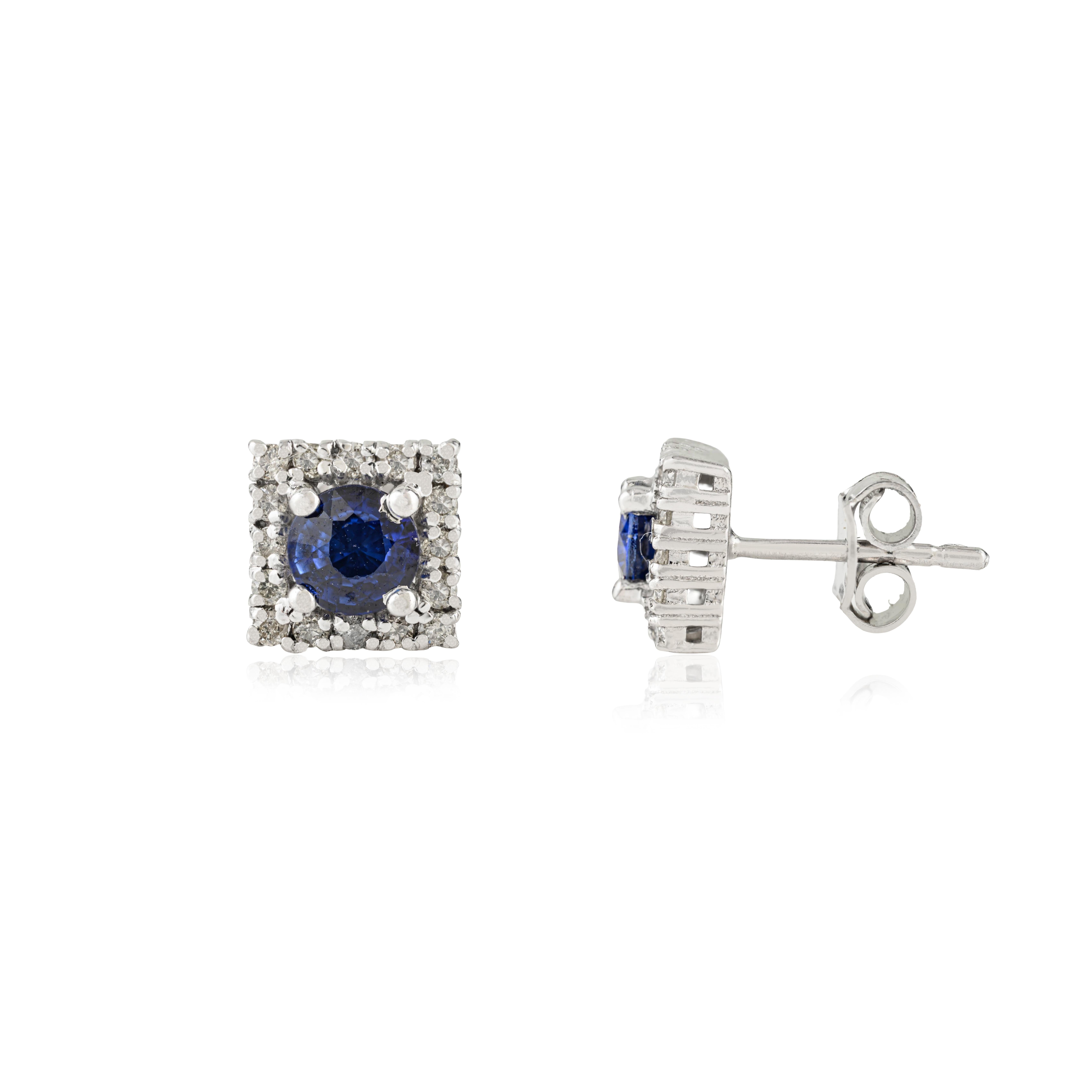 These 925 sterling silver stud earrings feature a contemporary square design. Each earring showcases a vibrant round blue sapphire at the center, beautifully framed by a sparkling halo of diamonds for captivating brilliance. The deep blue sapphires