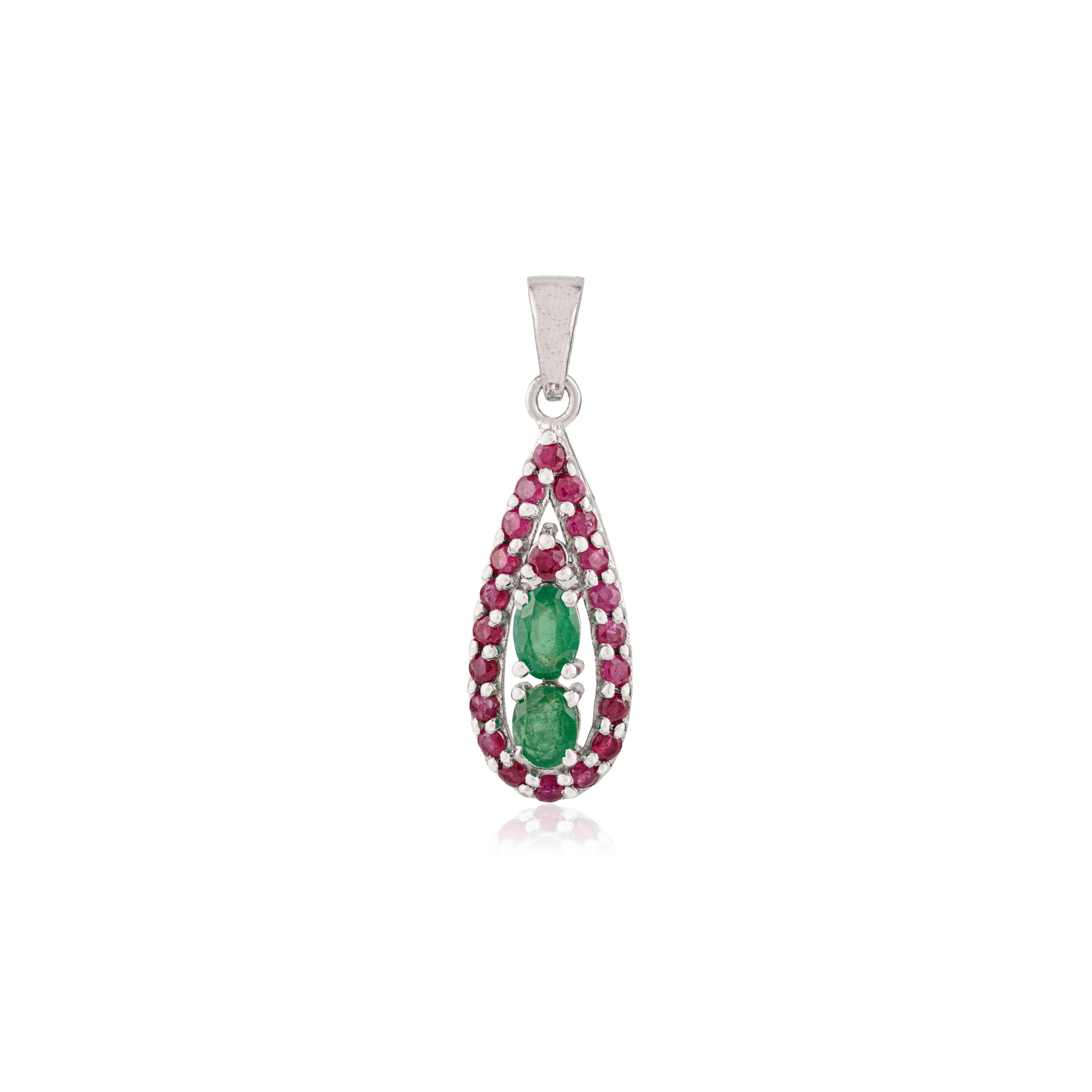 This exquisite 925 sterling silver pendant features a striking blend of genuine ruby and emerald gemstones. The design highlights an elegant mix of oval and round shapes, showcasing rubies and emeralds measuring 5x3 mm, 4x4 mm, and 2 mm in diameter.