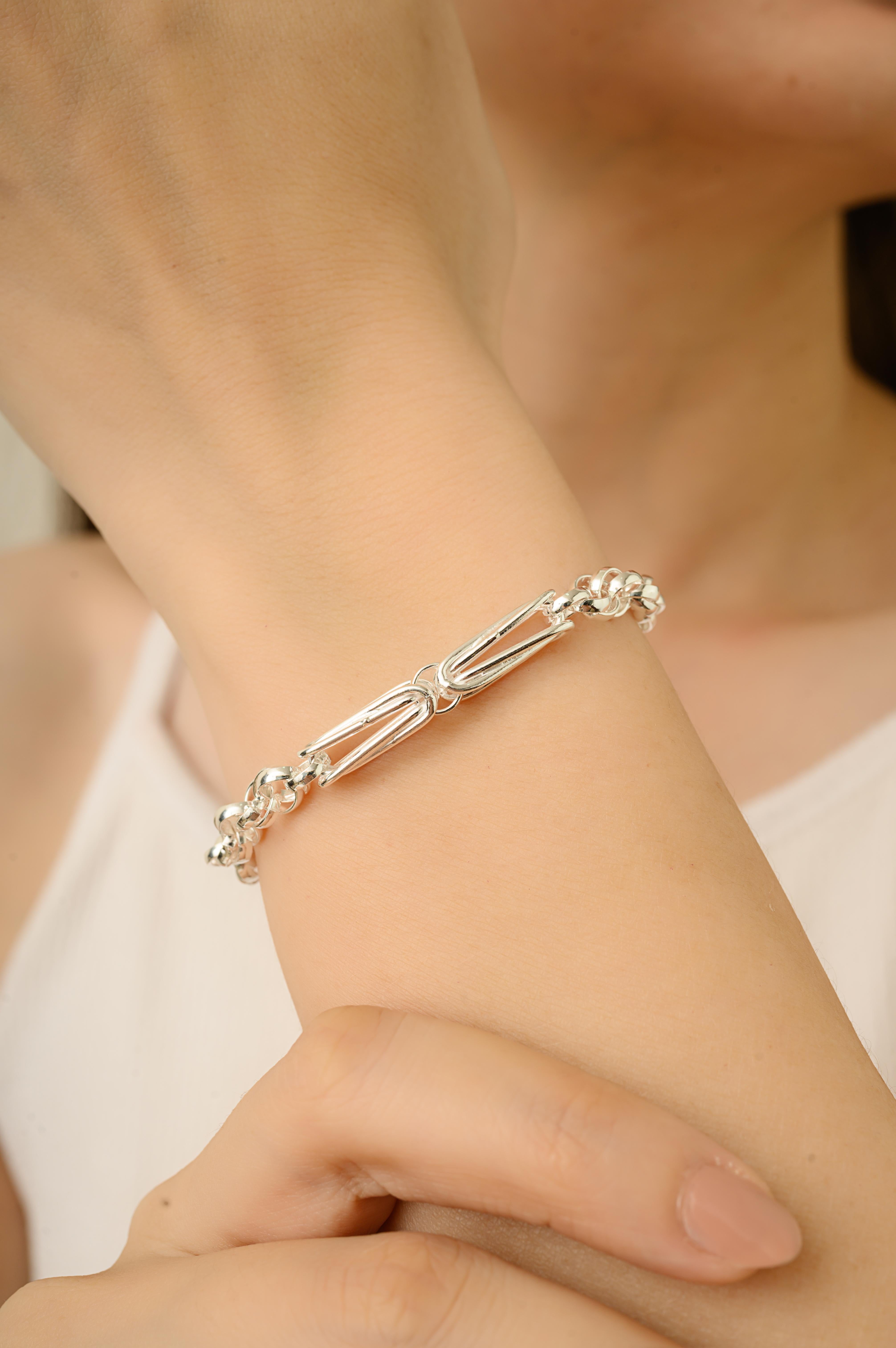 This 925 sterling silver bracelet features a smooth, polished finish and a stylish link design. Weighing 16.4 grams, it measures 8.25 inches in length, 0.22 inches in width, and 0.21 inches in depth. Crafted from solid silver, it is durable and safe