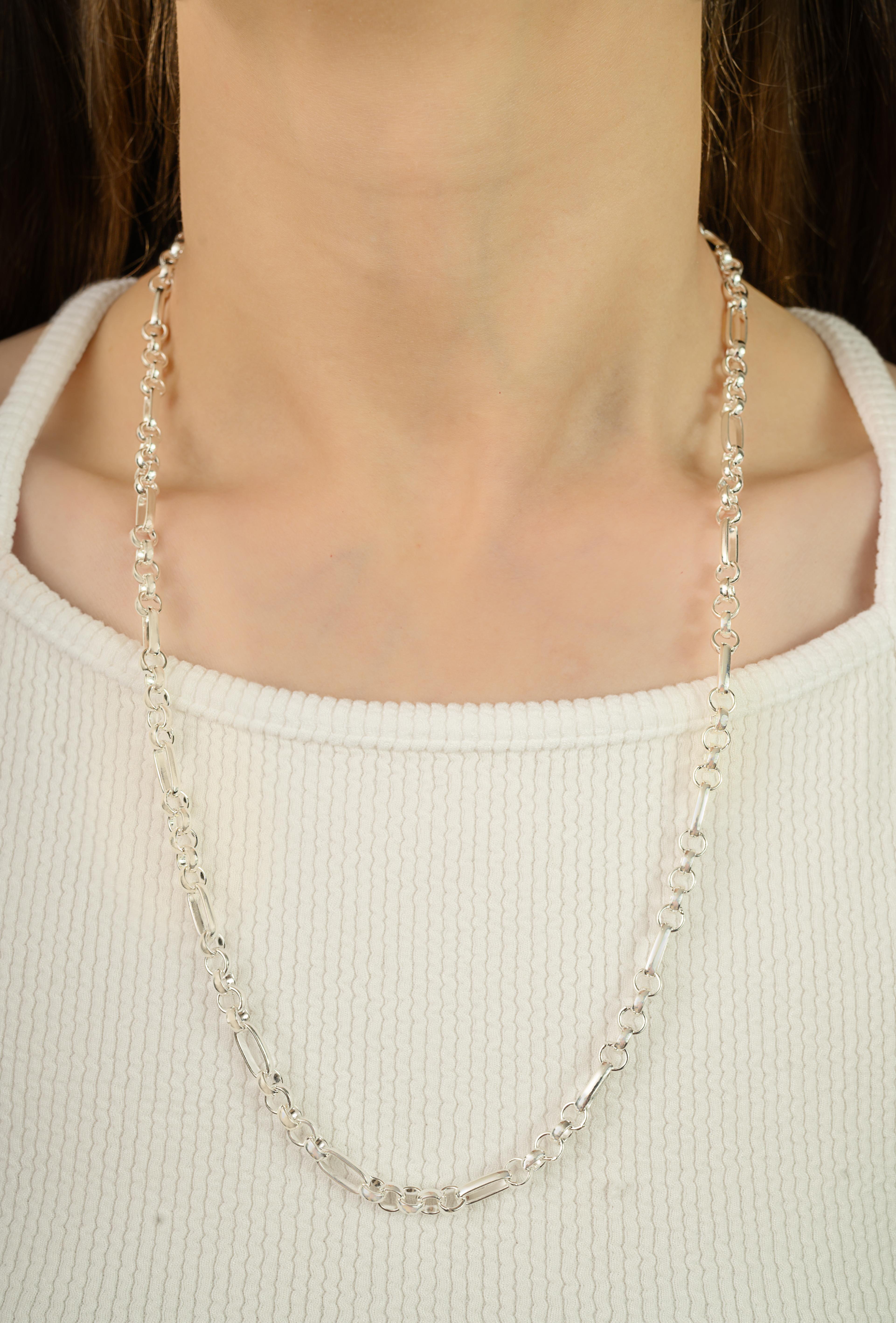 Fashioned from pure 925 sterling silver, this necklace showcases a clean alternating link pattern with a natural silver finish. Weighing 38.4 grams, it rests with a balanced and comfortable presence around the neck. The design measures 24 inches in