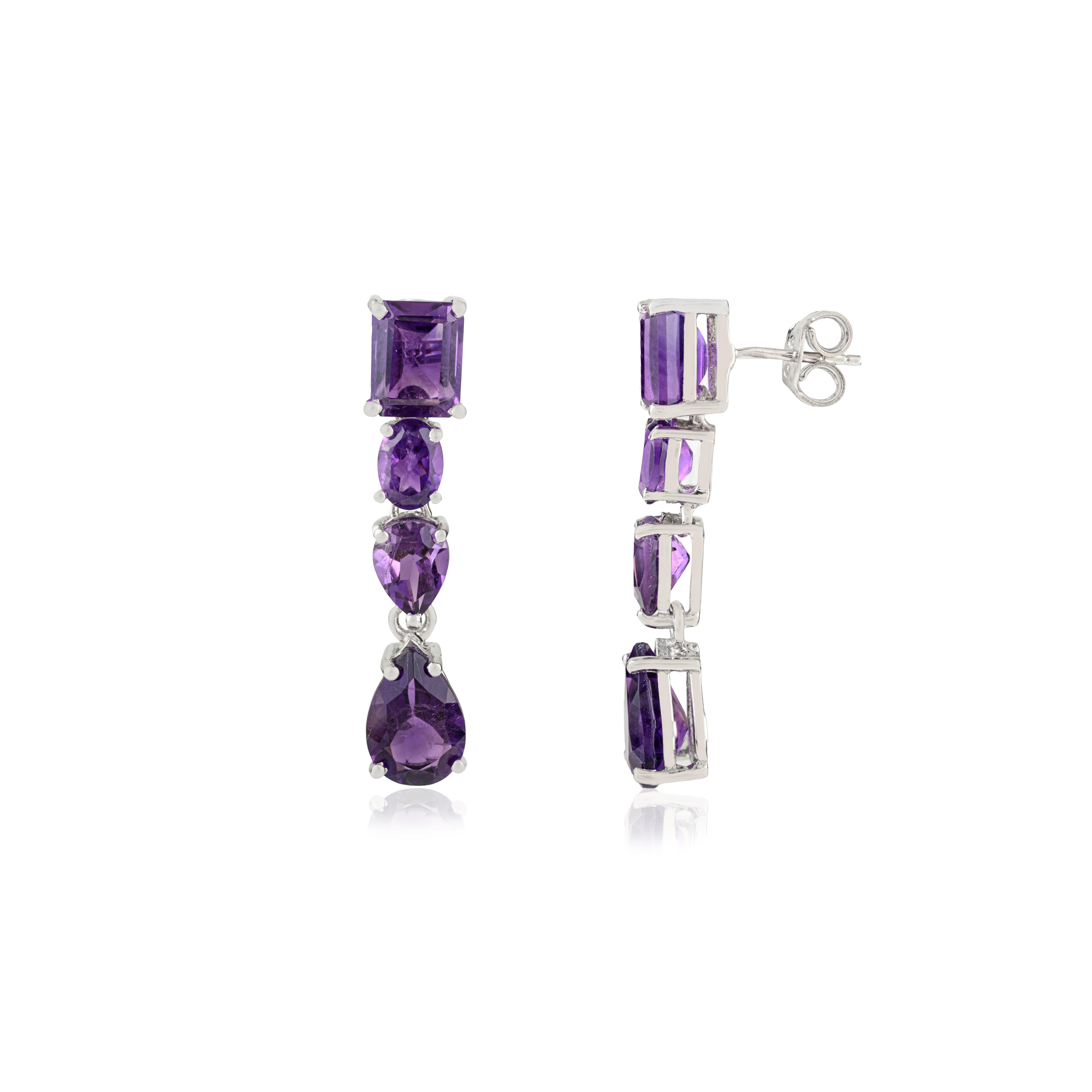These 925 sterling silver dangle earrings feature natural amethyst gemstones arranged in a captivating mix of cuts. Each earring showcases eight amethyst stones with a combined weight of 14.55 carats, displaying rich purple hues and exceptional