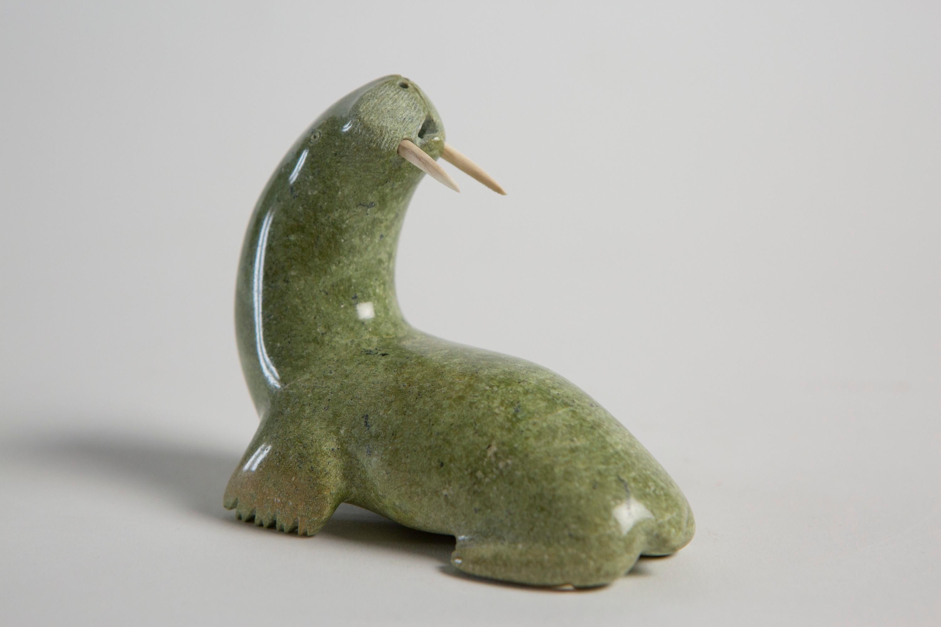 SIMANEK SAGIATUK (1930-) Stone Walrus, Lake Harbour / Kimmirut - Signed 

Simanek Sagiatuk is an Inuit art sculpture carver from the Lake Harbour community. He used to work mostly with serpentine, a very hard stone which is originally from