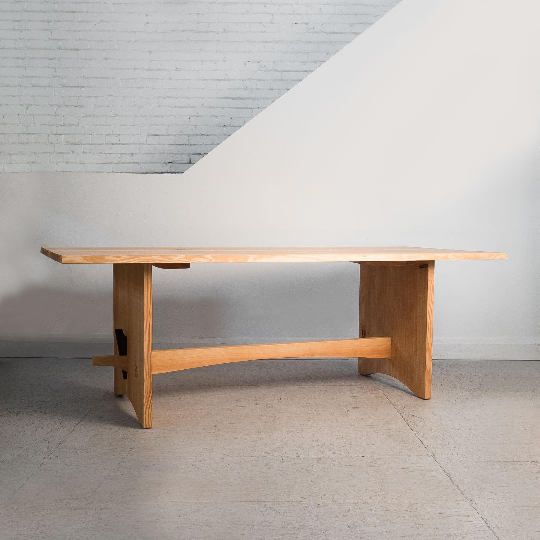 Full of unique character and natural beauty, the Simard dining table features a split tabletop with waney edge detailing. 

The simple structure is designed to be assembled with a mallet and nothing else. The bottom rail which passes through the