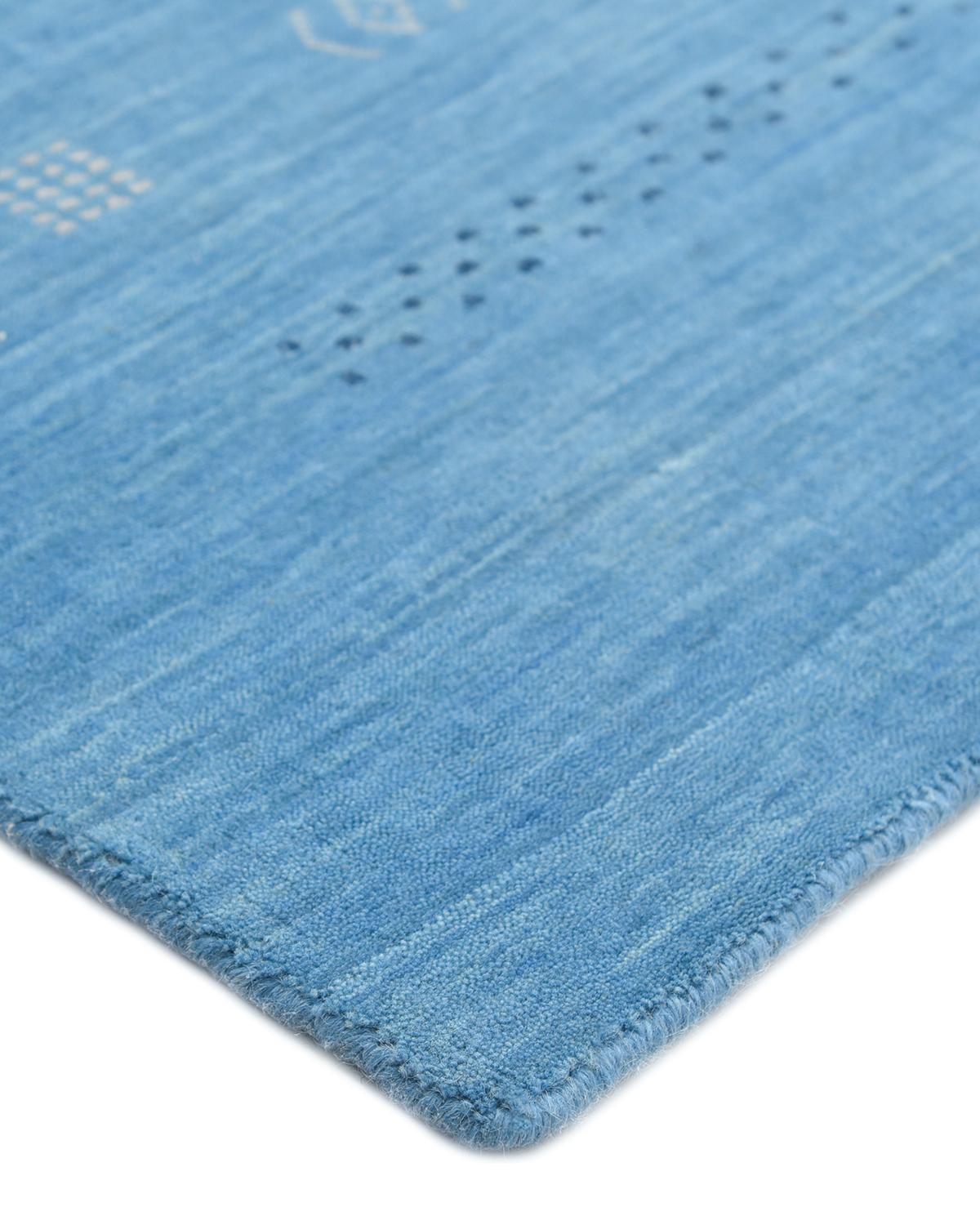 Color: Sapphire. Made in: India. 80% wool, 20% cotton. The nomads of Iran’s Zagros Mountains wove the original Gabbeh rugs in part to keep themselves warm on cold winter nights. In tribute to those original designs, this collection boasts a
