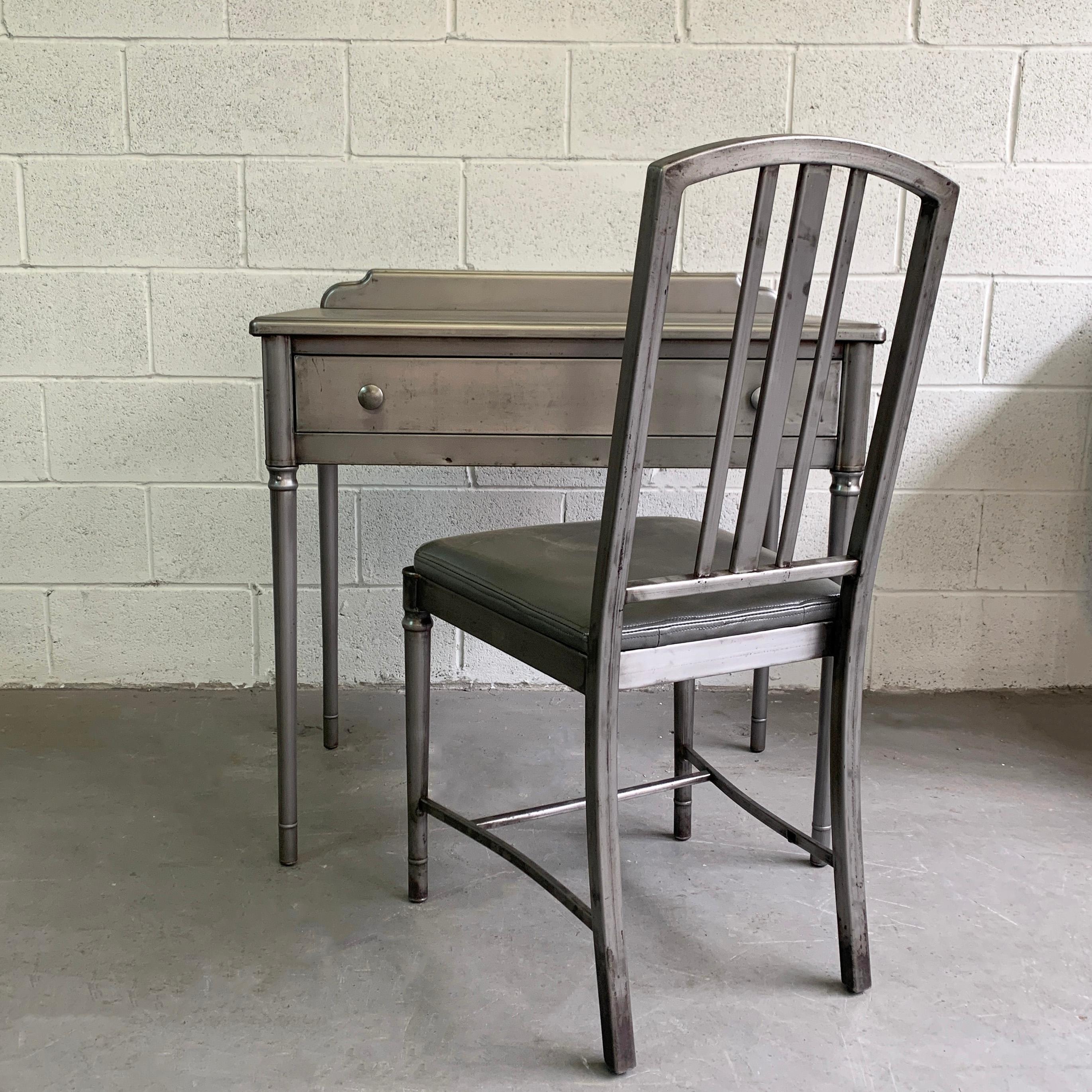 Early 20th century, Sheraton series vanity or desk set by Simmons Company Furniture features an upholstered gray vinyl chair seat with gray drawer interior. Leg room height is 22.5 inches and the lip on the back of the desk is 2.5 inches height. The