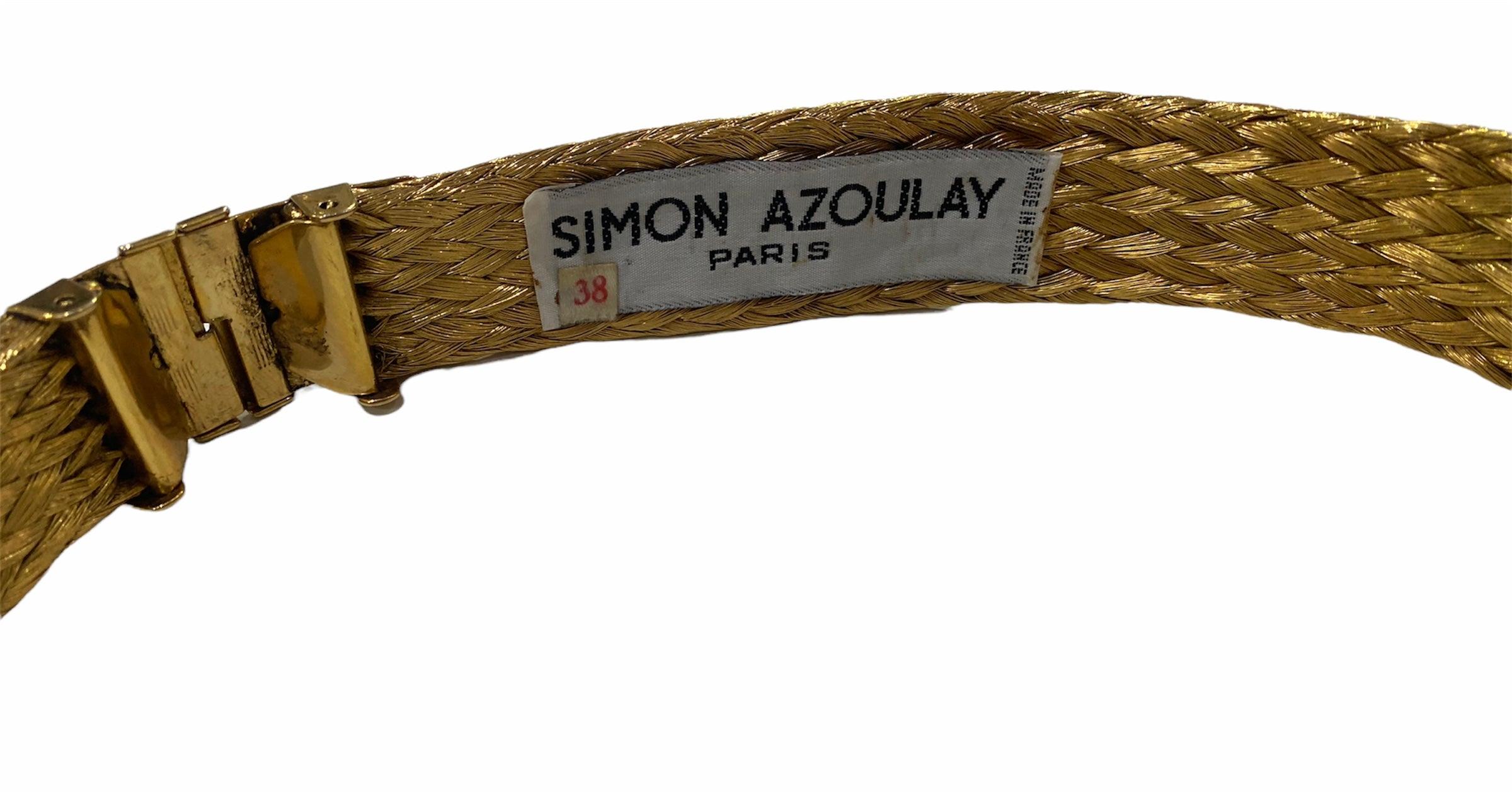 From Simon Azoulay - famous for his work with metallic materials. Belt made of braided strands of highly polished brass with hook closure in back. Front accented with two 