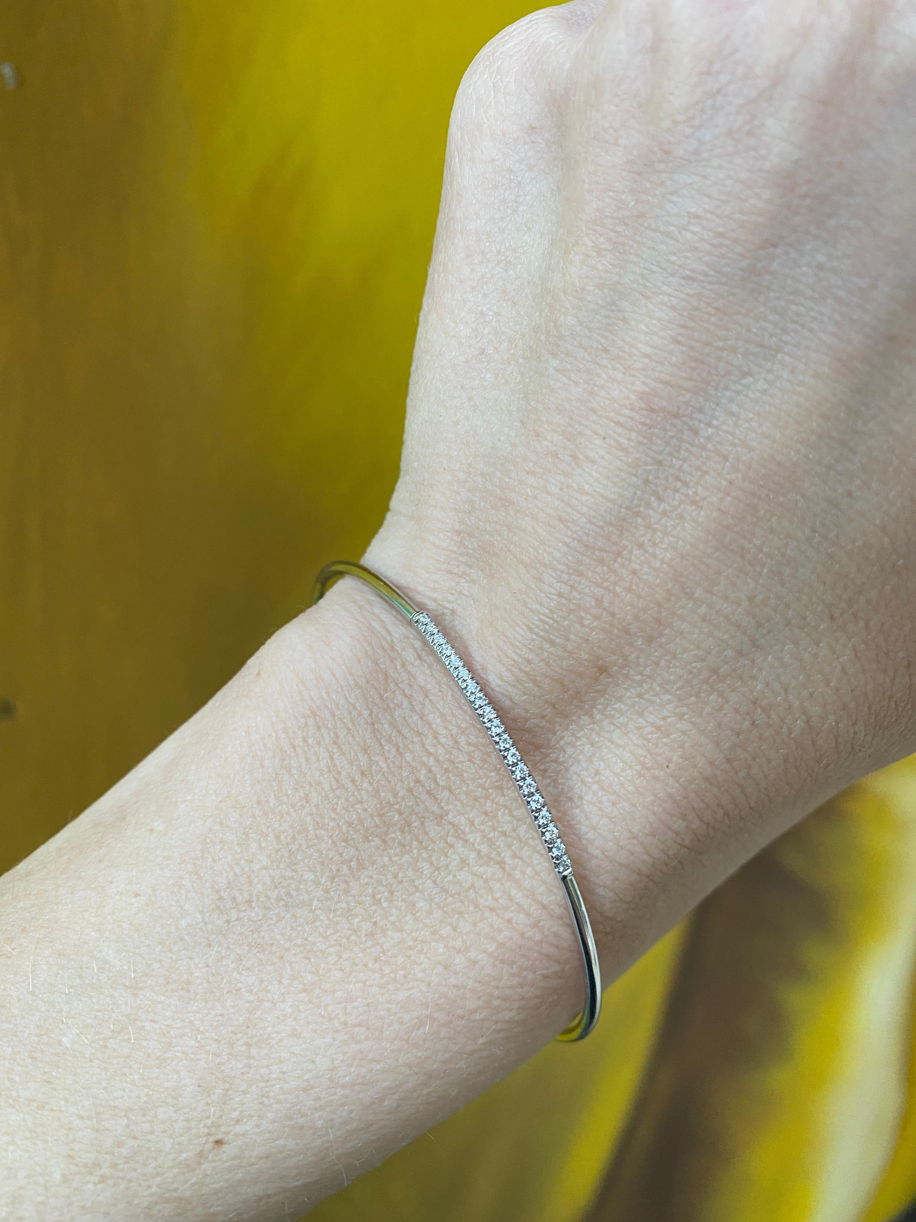 This delicate bangle from Simon G. is crafted in 18 karat white gold and features 0.13 carat total weight in round diamonds in a simple line. This bracelet can be worn on its own but is perfect for stacking. This will fit up to a size 6.5