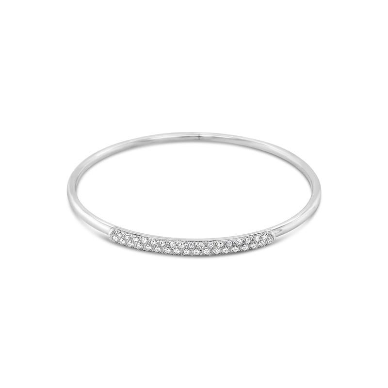 A contemporary bangle crafted in 18 karat white gold and features 0.36 carat total weight in white diamonds. It can be stacked with other bracelets or worn alone. This will fit up to a size 6.5