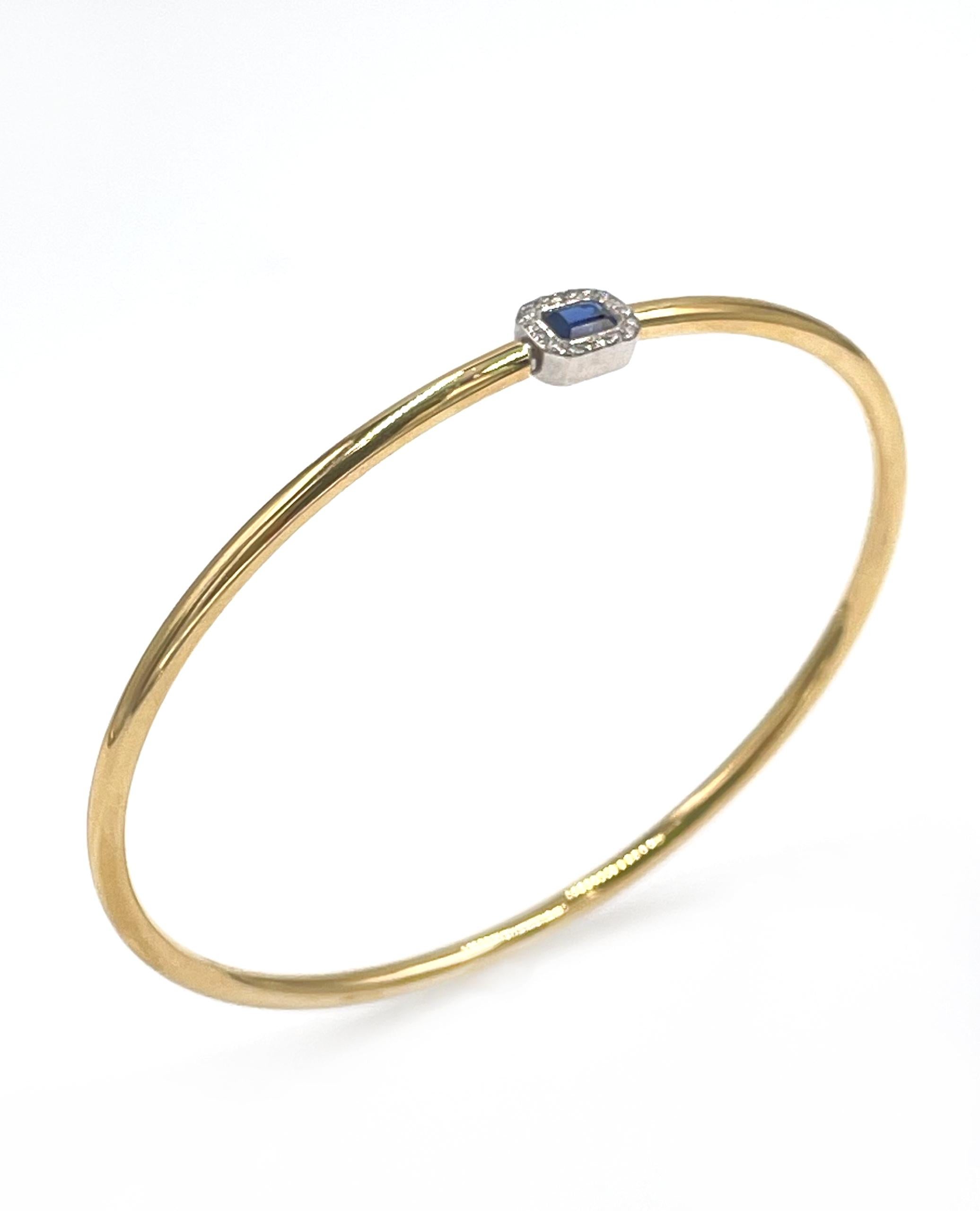 Simon G. 18K yellow and white gold bangle bracelet with 18 round brilliant-cut diamonds 0.05 carat and 1 emerald cut blue sapphire weighing 0.35 carat.

- Style No. LB2494
- Diamonds are G/H color, SI clarity