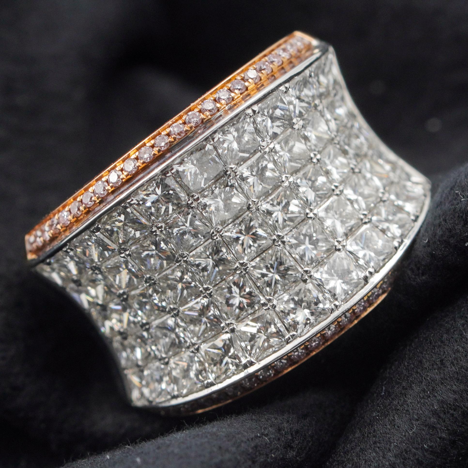 This brilliant two-tone diamond ring plays with the light and is sure to stand out on your finger. The piece is covered in Pave Diamonds totaling 4.17 Carats. The central pave is framed by small pink diamonds set in the rose gold on either side of