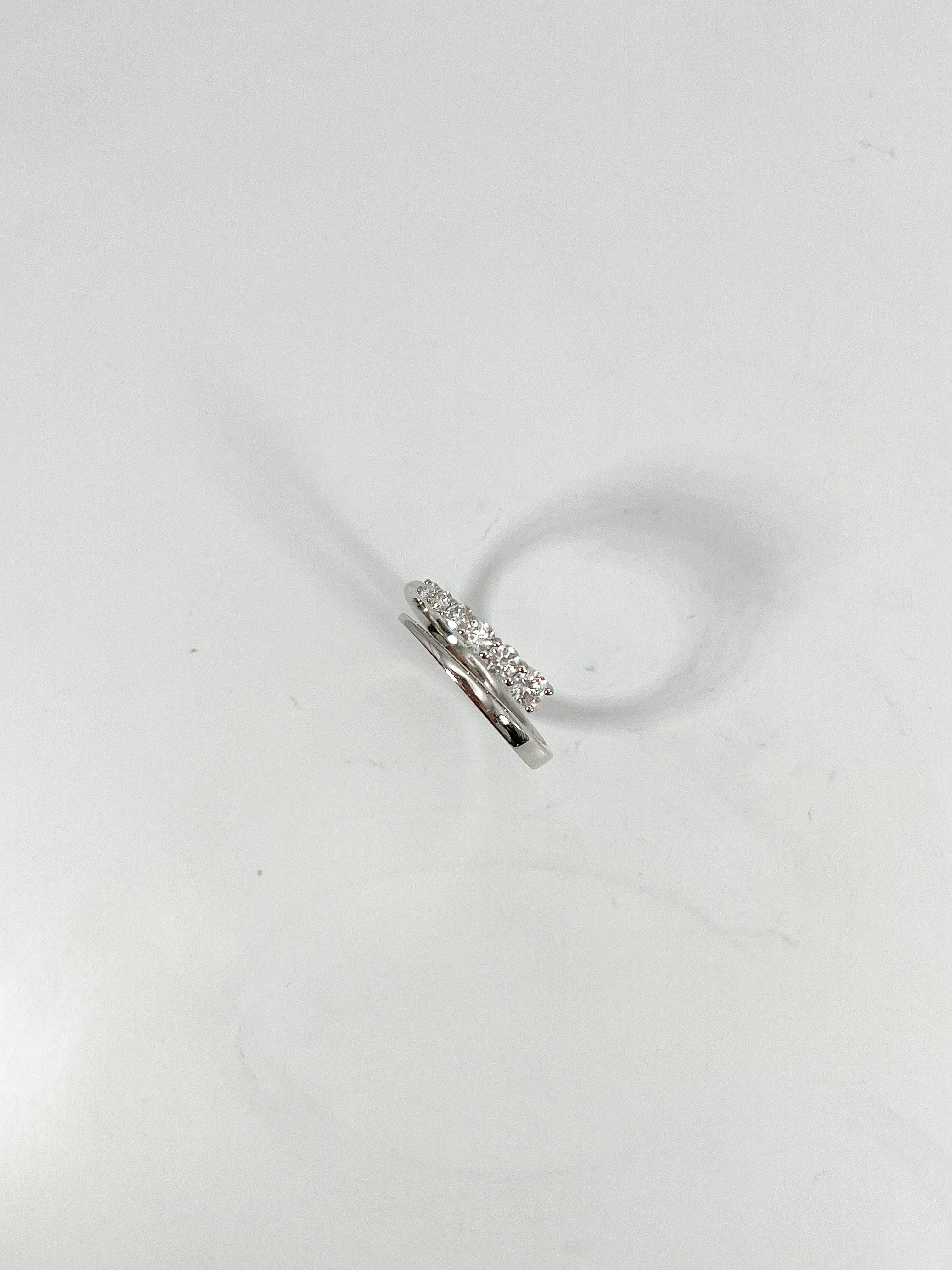 Simon G 18k white gold .36 CTW diamond crossover ring. The diamonds in this ring are all round, the width is 5.5 mm, the size of the ring is a 6 3/4, and it has a total weight of 2.7 grams. 
Part number- LR2499