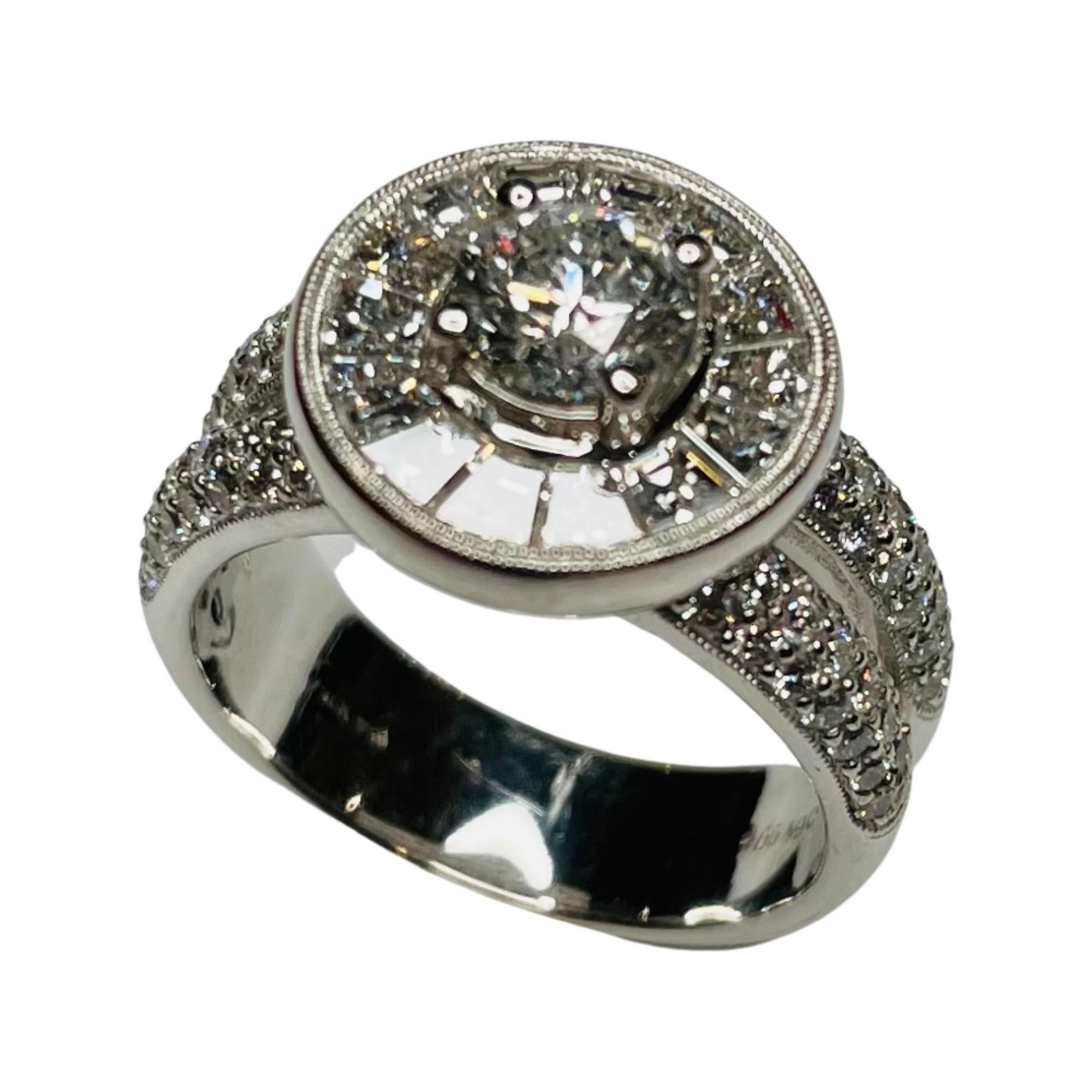Simon G 18K White Gold and Diamond Ring. The center diamond is 0.73 carats. It is 4 prong set. It is VS2 clarity and G color. It is surrounded by 14 tapered baguettes channel set. They have a total weight of 1.19 carats. They are VS clarity and G