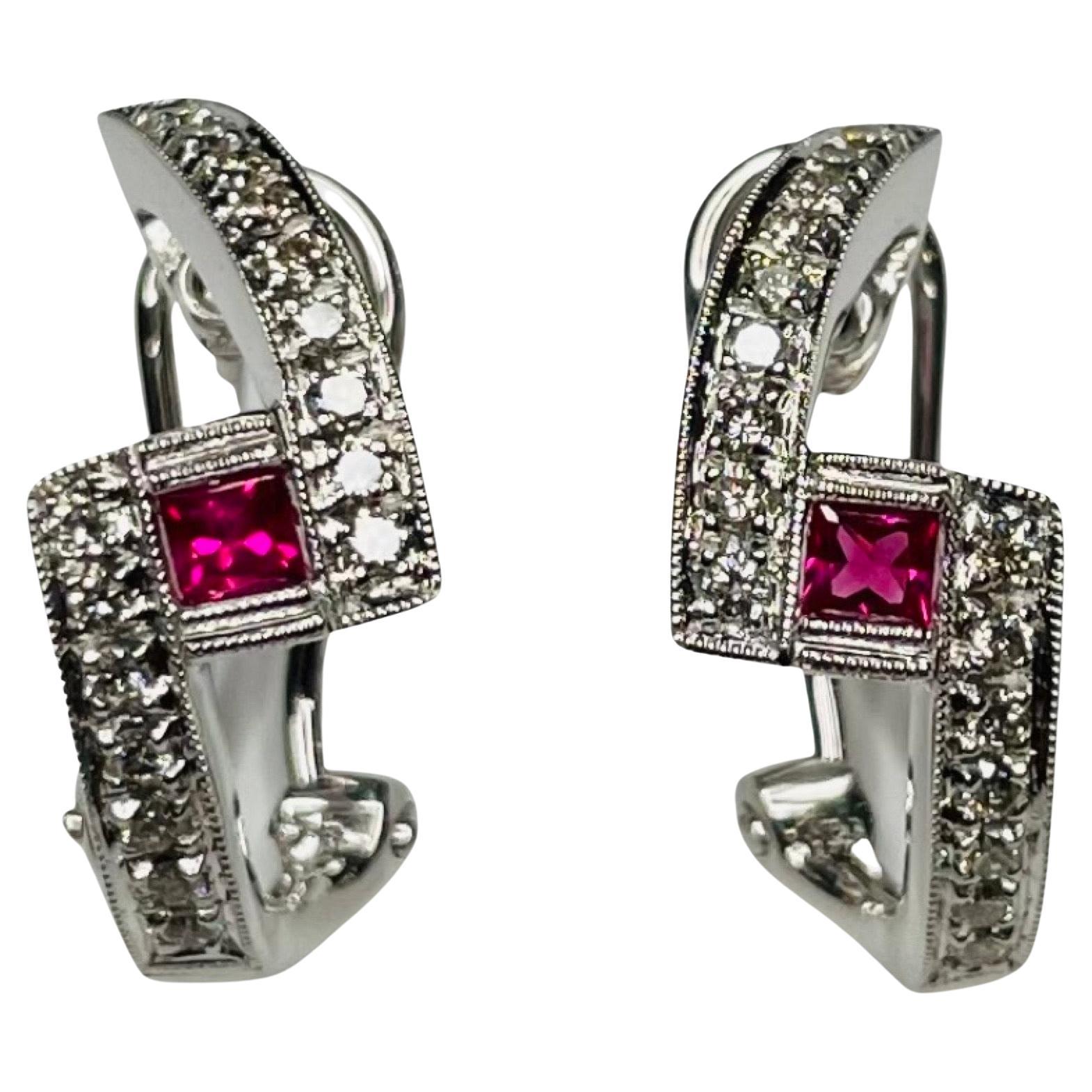 Simon G 18K White Gold Natural Ruby and Diamond Earrings. The earrings are 18.0 mm long. The rubies have a total weight of 0.23 carats. There are 32 full cut round brilliant diamonds of VS clarity and G color for a total diamond weight of 0.30