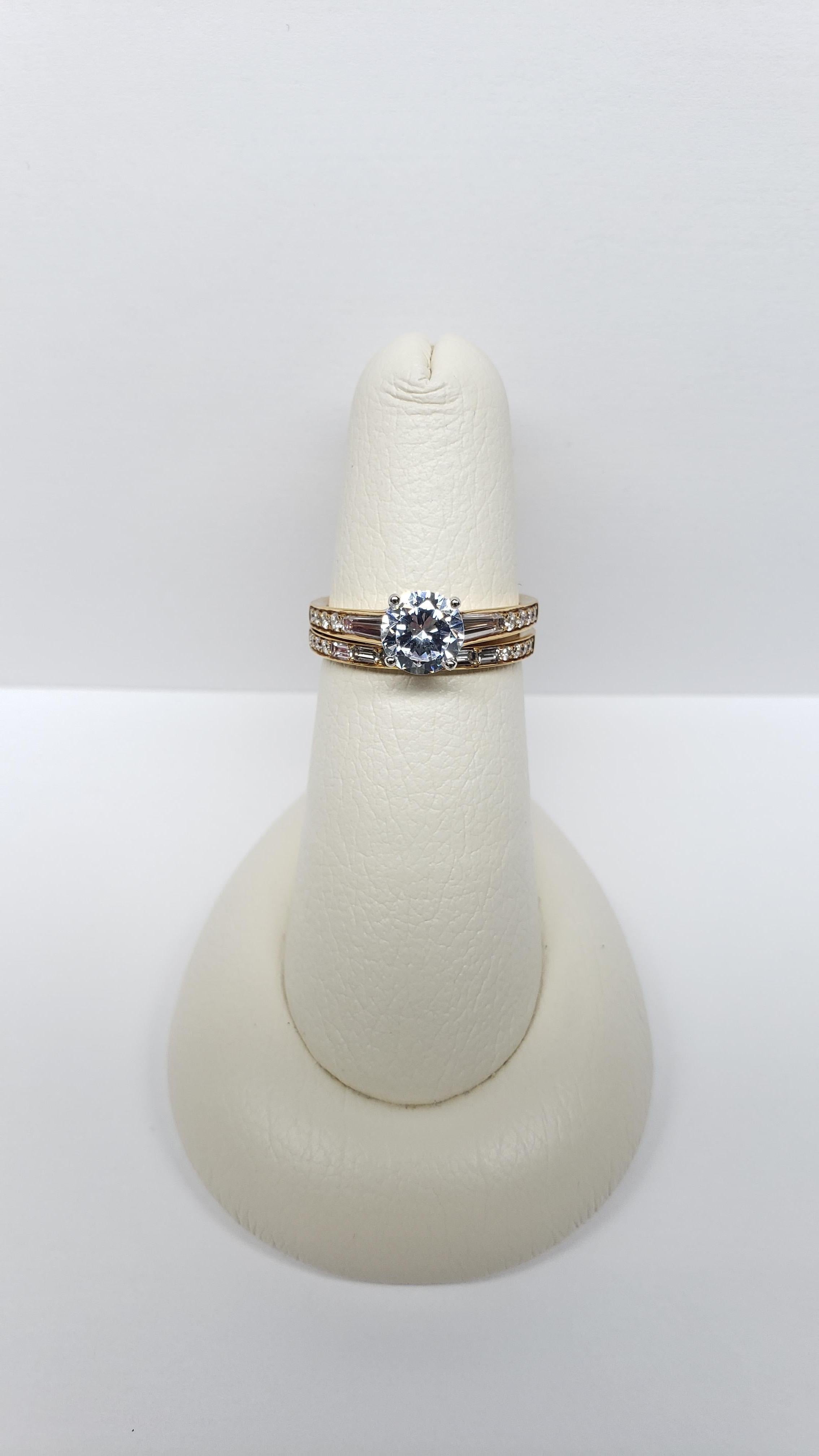 This wedding set was designed by Simon G. and made from 18k yellow gold with white gold prongs. It features and elegant tapered engagement band, and a classic diamond and gold wedding band, Both rings feature baguette and round brilliant diamonds in