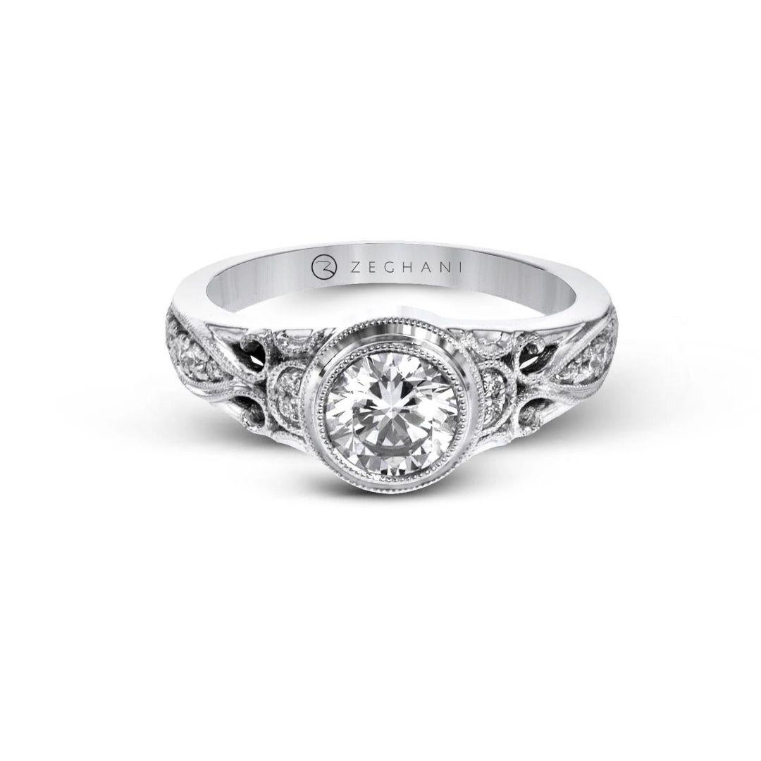 This 14k gold engagement ring is full of vintage-inspired details like filigree and milgrain and contains 0.13 ctw of white round brilliant diamonds, G color, VS2 clarity. Created for Zeghani by couture bridal designer Simon G. Center Diamond NOT