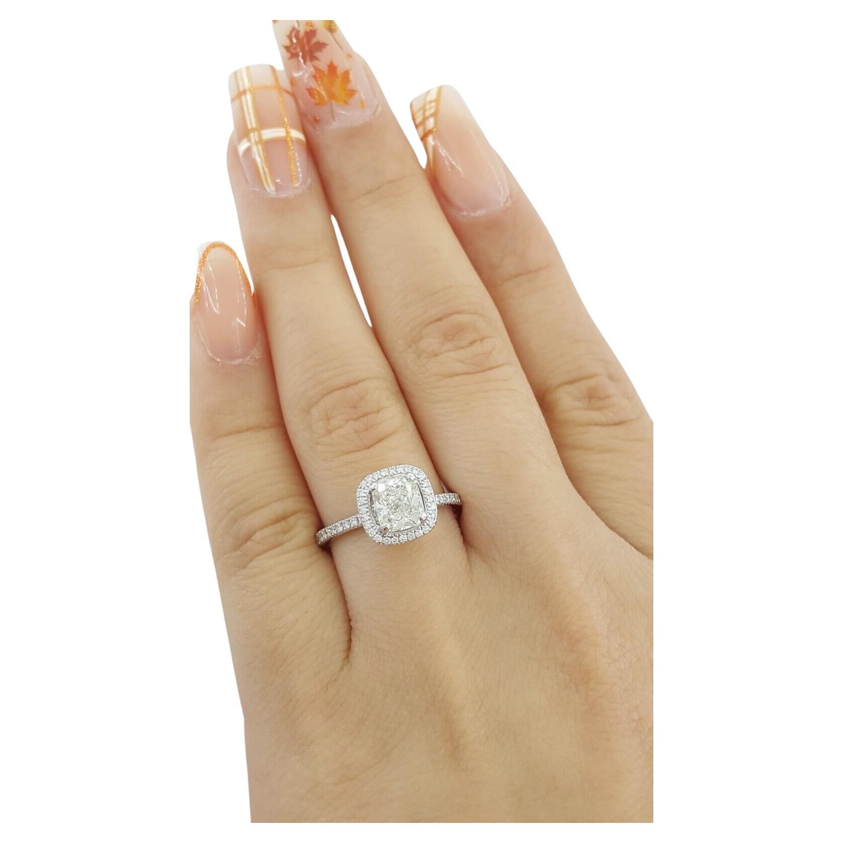 The engagement ring features a 1.3 carat total weight Cushion Brilliant Cut diamond surrounded by a halo, set in 14k White Gold. The ring is sized 5.25 and weighs 2.8 grams. The center stone is a Natural Cushion Brilliant Cut diamond, weighing 0.97