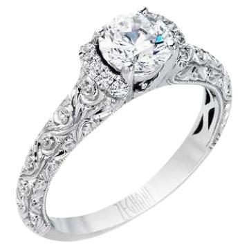 With elegant scroll work engravings and milgrain edges, this vintage inspired engagement mounting spells romance and femininity. Ring contains 0.08ctw of white diamonds, G color, VS2 clarity. It is part of the Vintage Vixen Collection from Zeghani