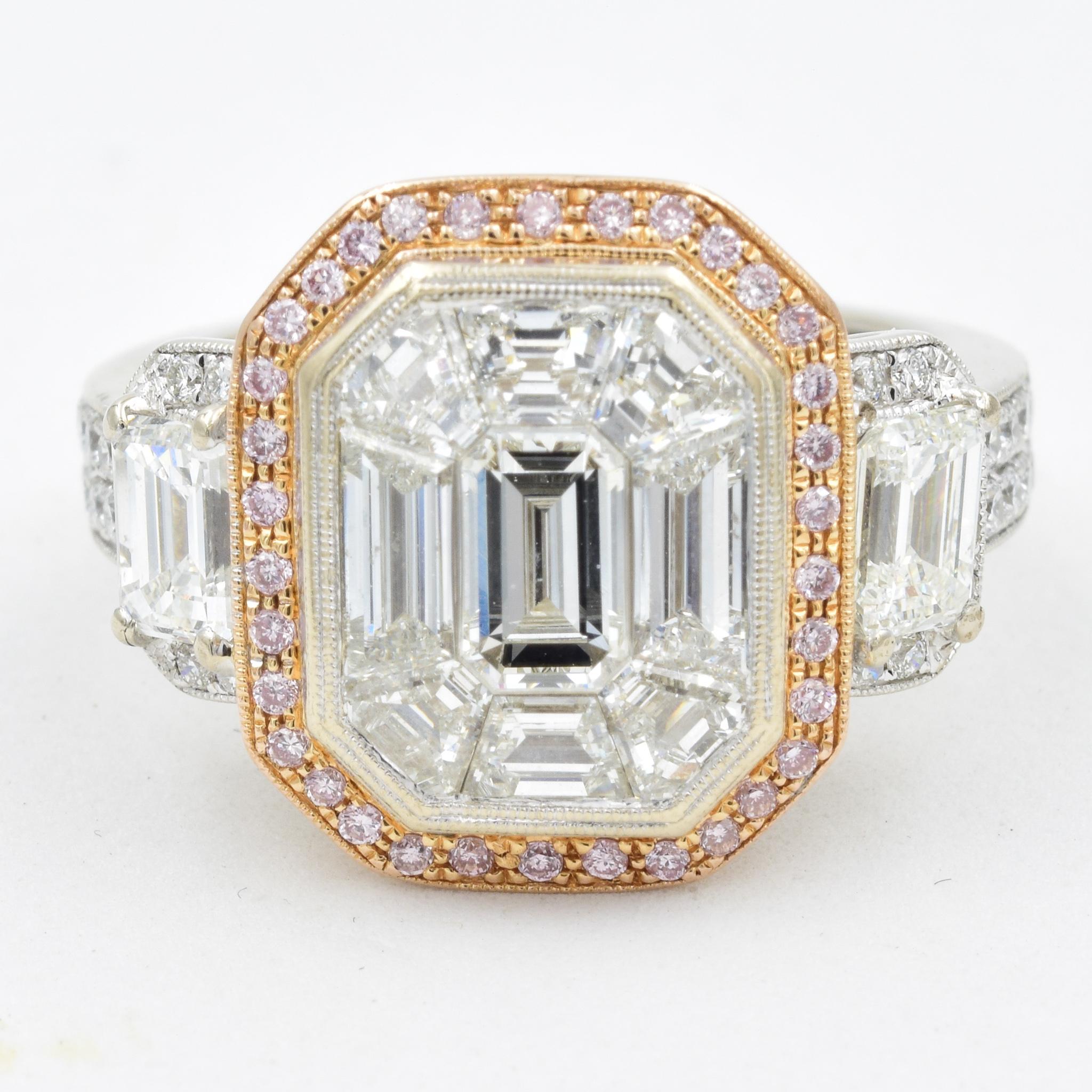 This model is a signature style by Simon G known as the Mosaic Diamond Engagement Ring.  The center mosaic diamonds total approximately 2.25 carats with a center emerald cut which is approximately 0.25 carats.  There are pave diamonds which total