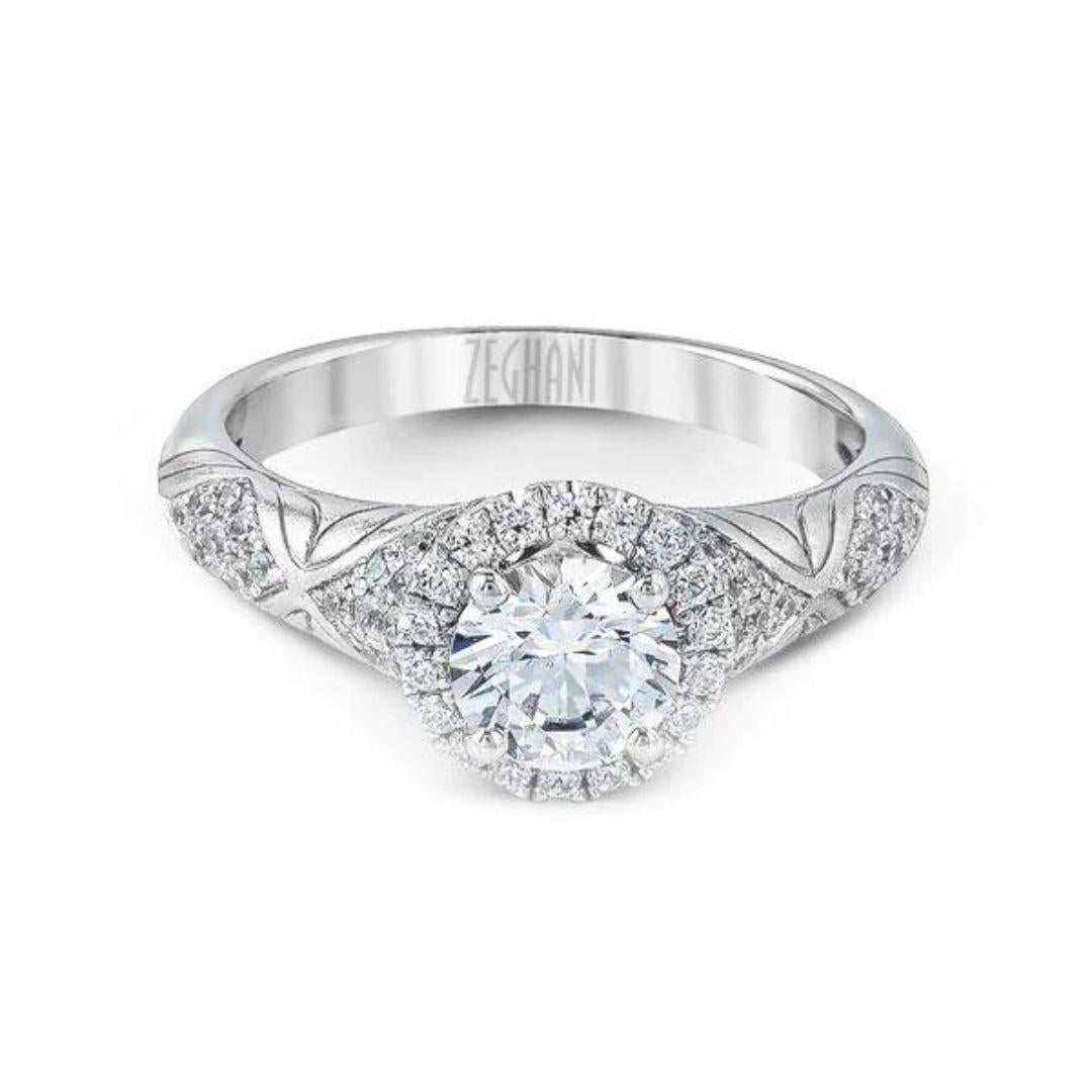 This intricate 14k white gold engagement mounting is part of the Vintage Vixen Collection from Zeghani by couture bridal designer Simon G. It features engraved etching and uses 0.46ctw of supporting diamonds to add some glitz to the style. Diamonds