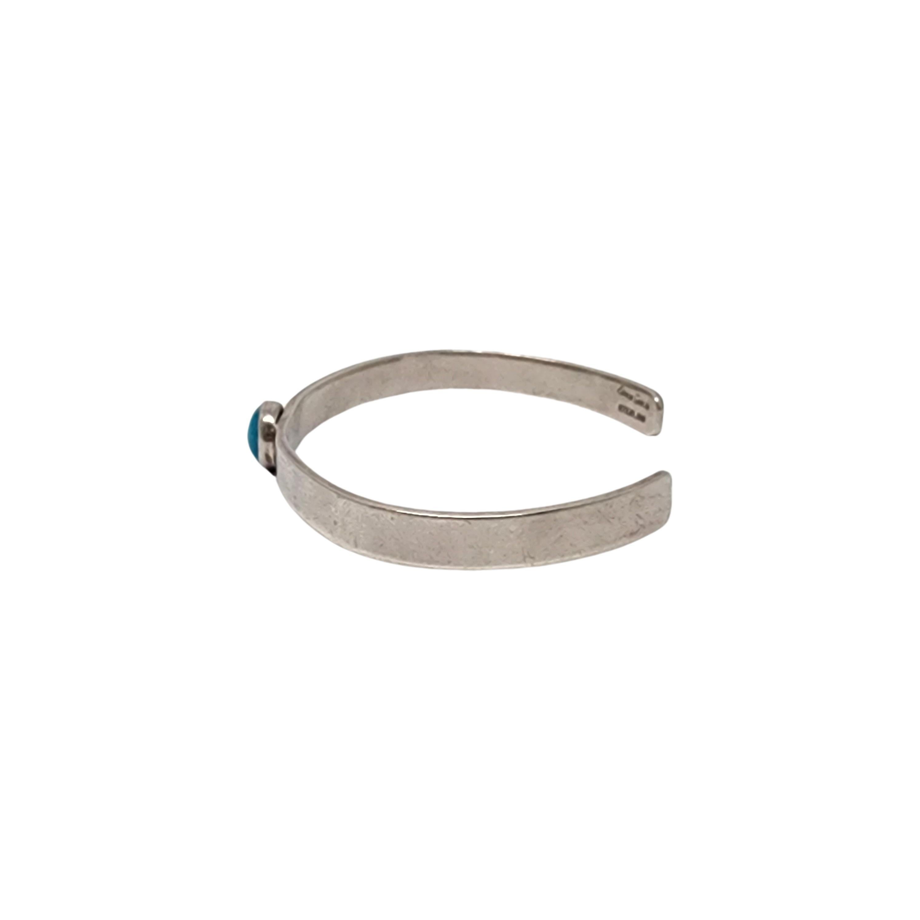Simon Garcia Santa Fe sterling silver and turquoise cuff bracelet.

A simple and classic design, thin sterling silver cuff bracelet featuring a round bezel set blue turquoise.

Weighs approx. 14.6g, 9.4dwt

Measures approx 6 1/2