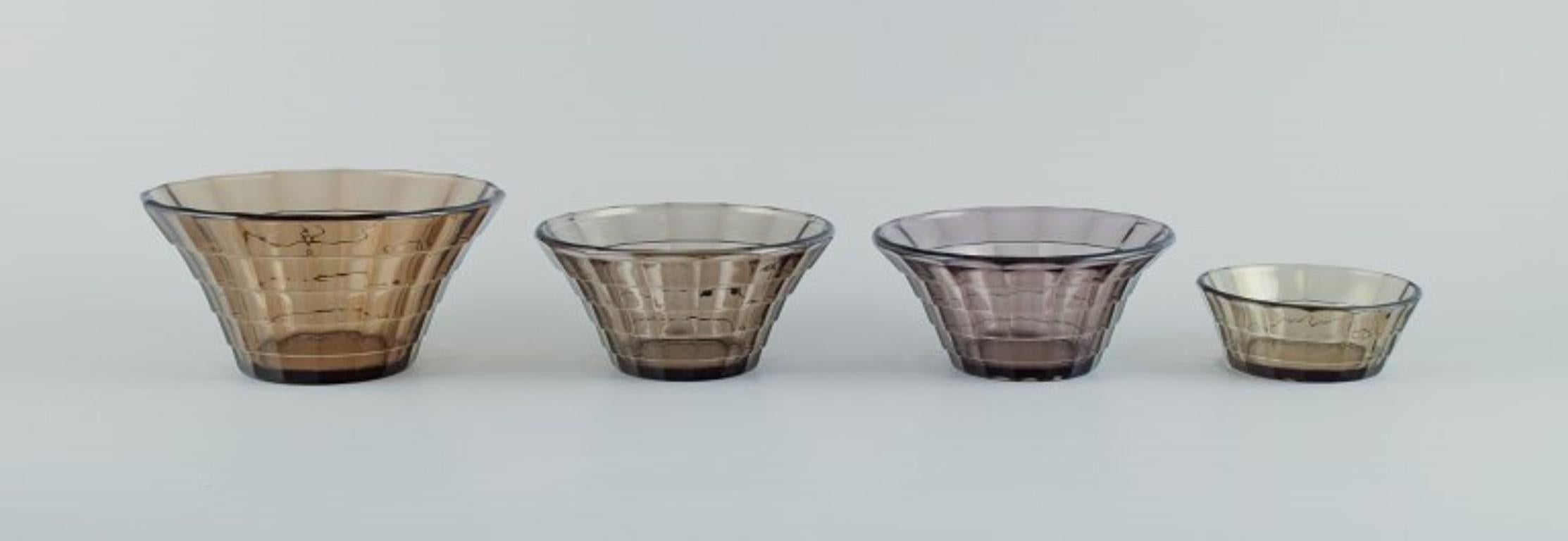 Simon Gate (1883-1945) for Orrefors/Sandvik, Sweden.
Set of four Art Deco bowls in smoked-coloured pressed glass.
Model G756.
Approximately from 1940.
In perfect condition.
Largest bowl measures: D 16.0 cm. x H 8.0 cm.
