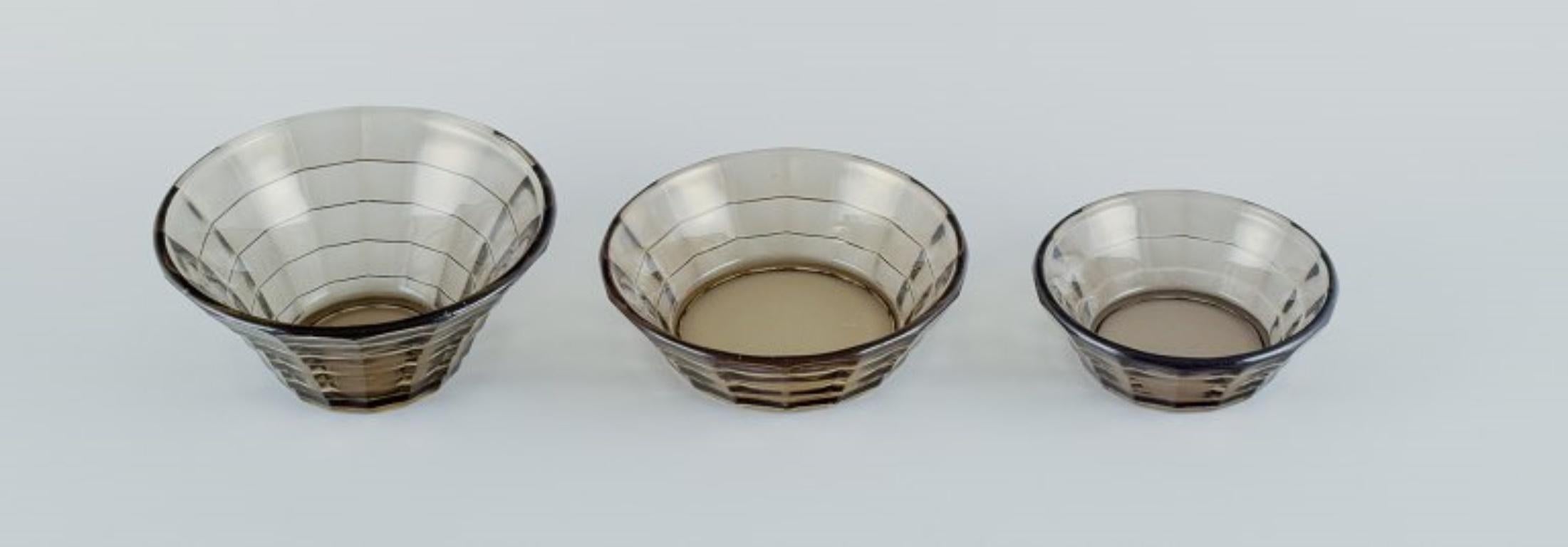 Simon Gate (1883-1945) for Orrefors/Sandvik, Sweden.
Set of three Art Deco bowls in smoked-coloured pressed glass.
Model G756.
Approximately from the 1940s.
In perfect condition.
Largest: D 13.5 cm x H 6.0 cm.